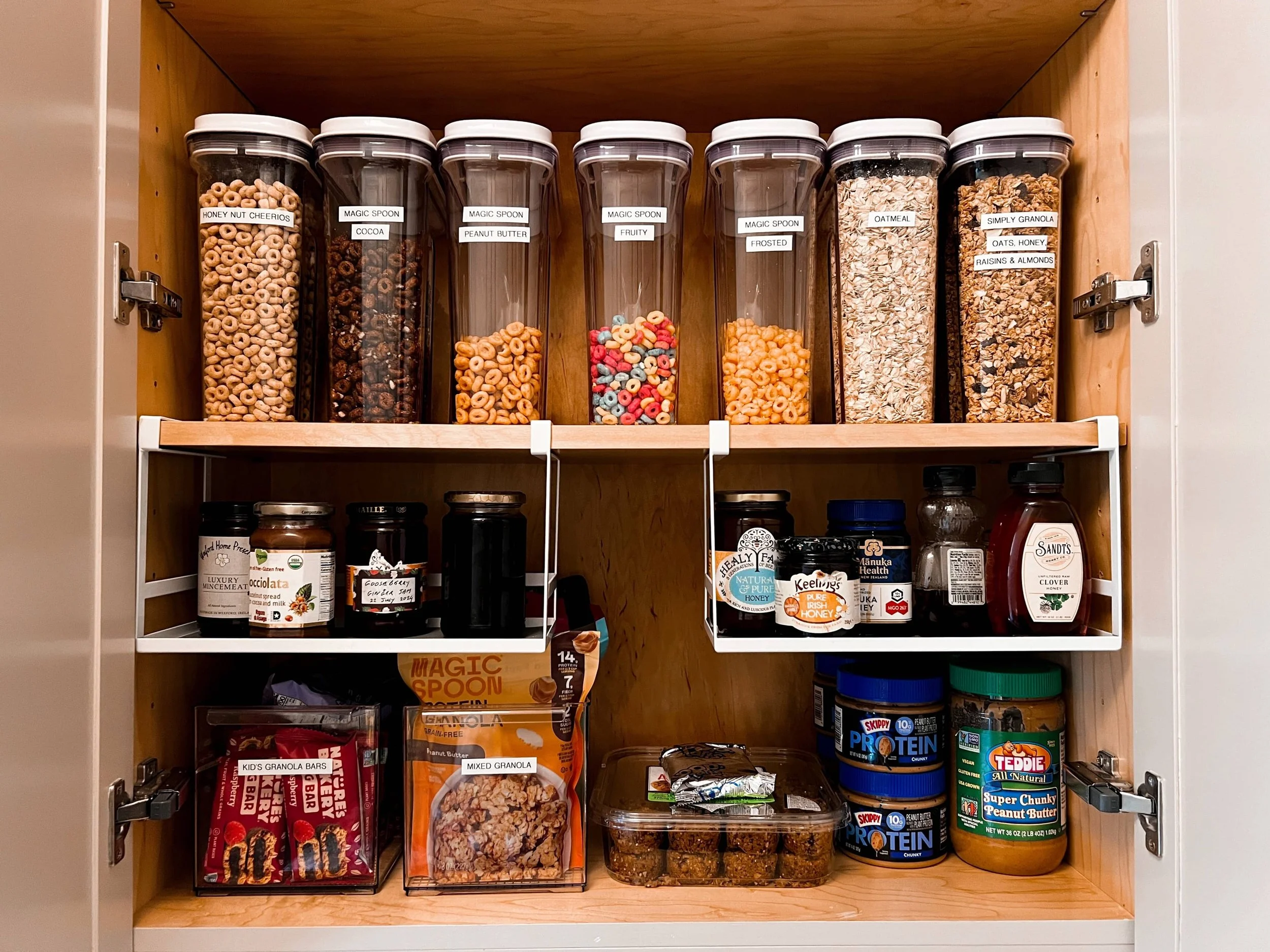A pantry with decanted goods and extra shelving.