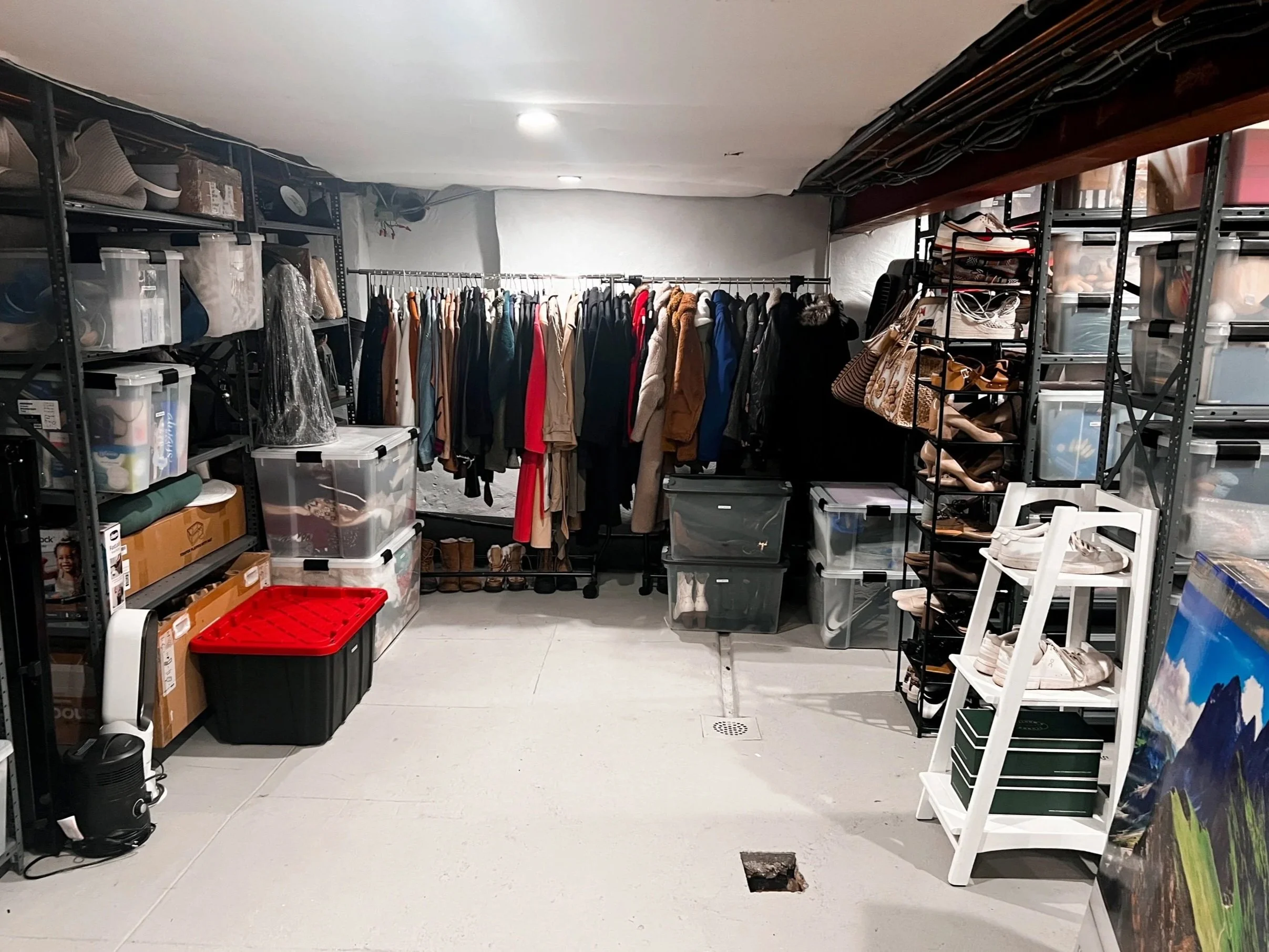 Basement organized with hanging racks and waterproof bin storage