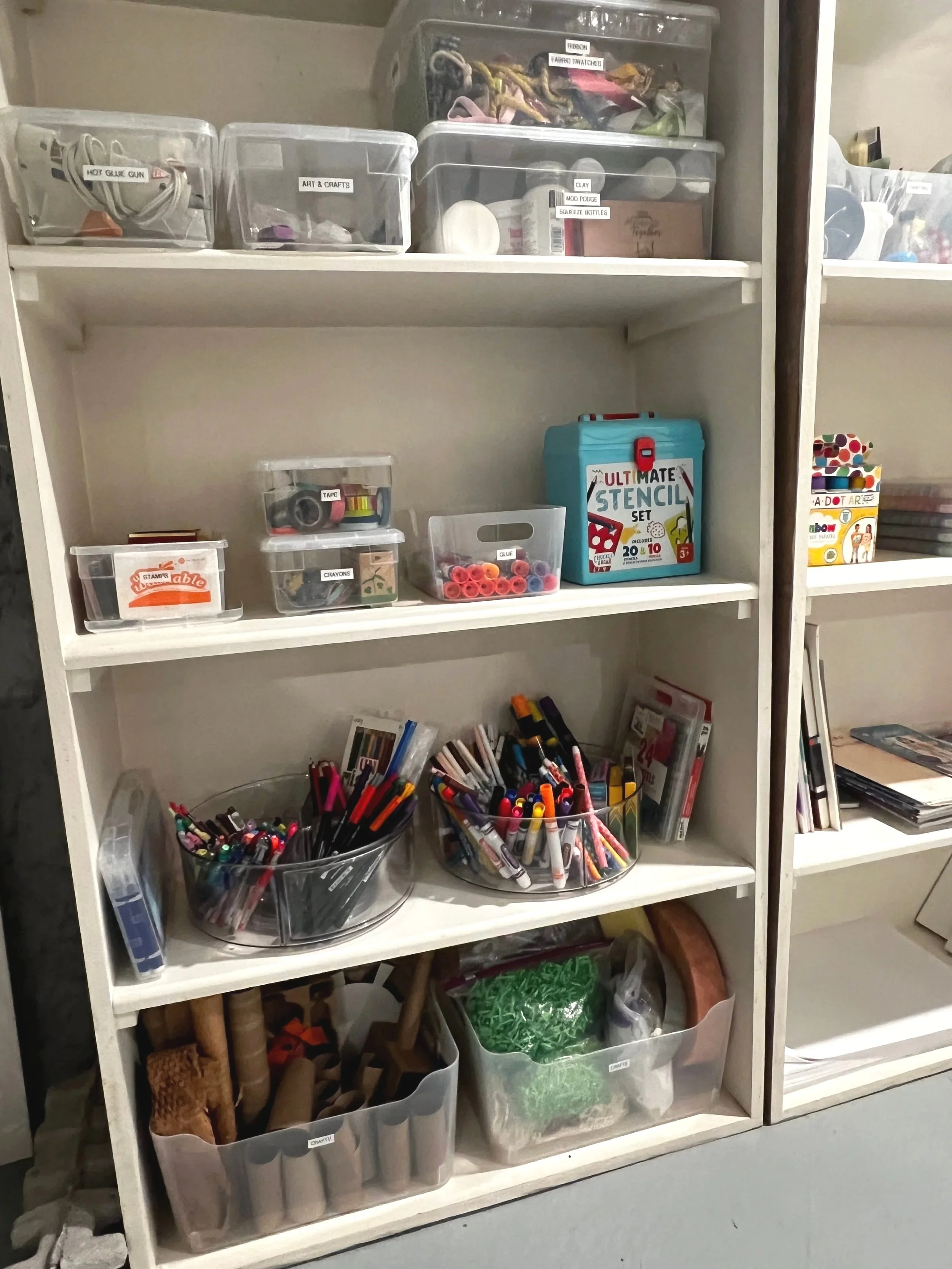 Art closet organized with clear bins