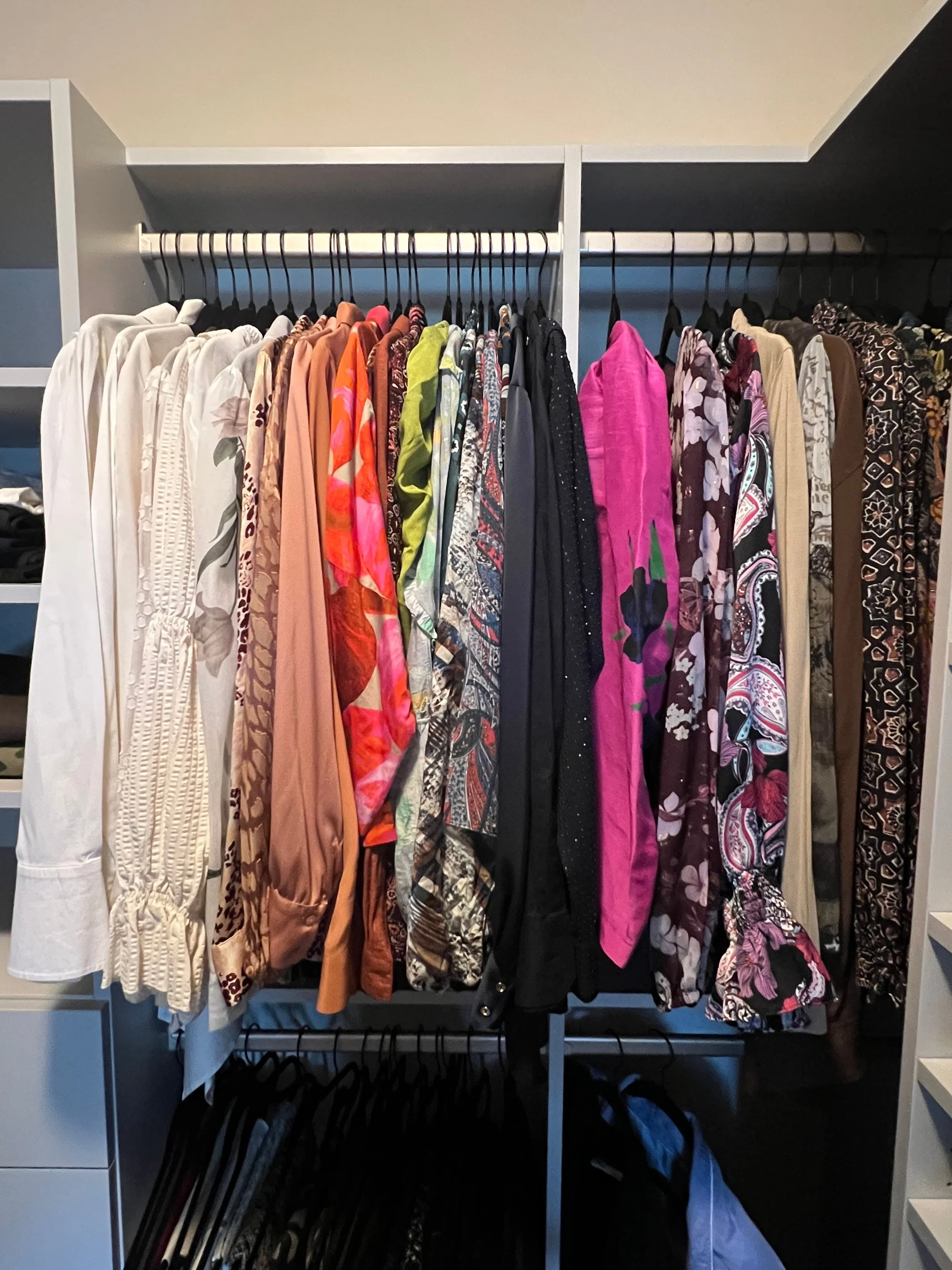 Primary closet with colorful women's clothing