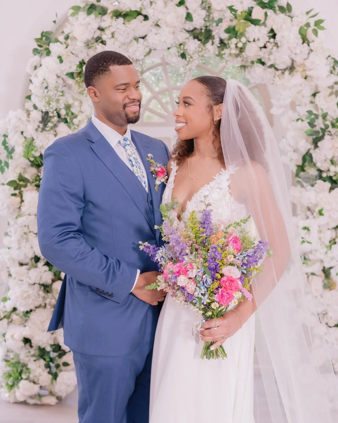 A wedding in full bloom! Colorful florals, dreamy hanging spring blooms, a cake with the sweetest pop of color, and a magical ending under the light-up oak tree. Pure joy from start to finish. 🌸💫

Venue: @heavenonearthoaks&nbsp;
Catering| DJ| Photo