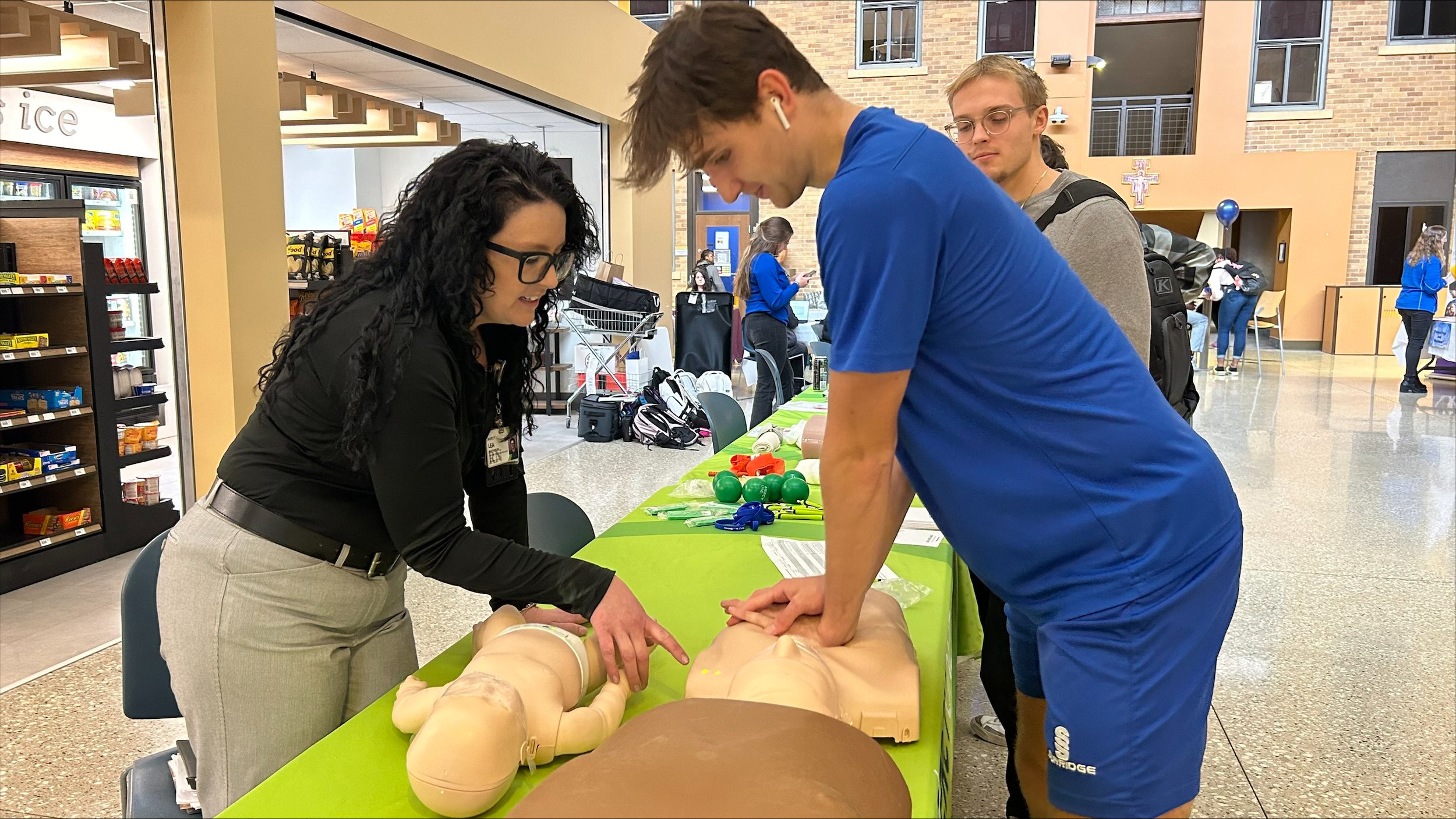  Lea from Mercy One shows the BCU soccer team what it takes to do CPR compressions on dummies.&nbsp; 