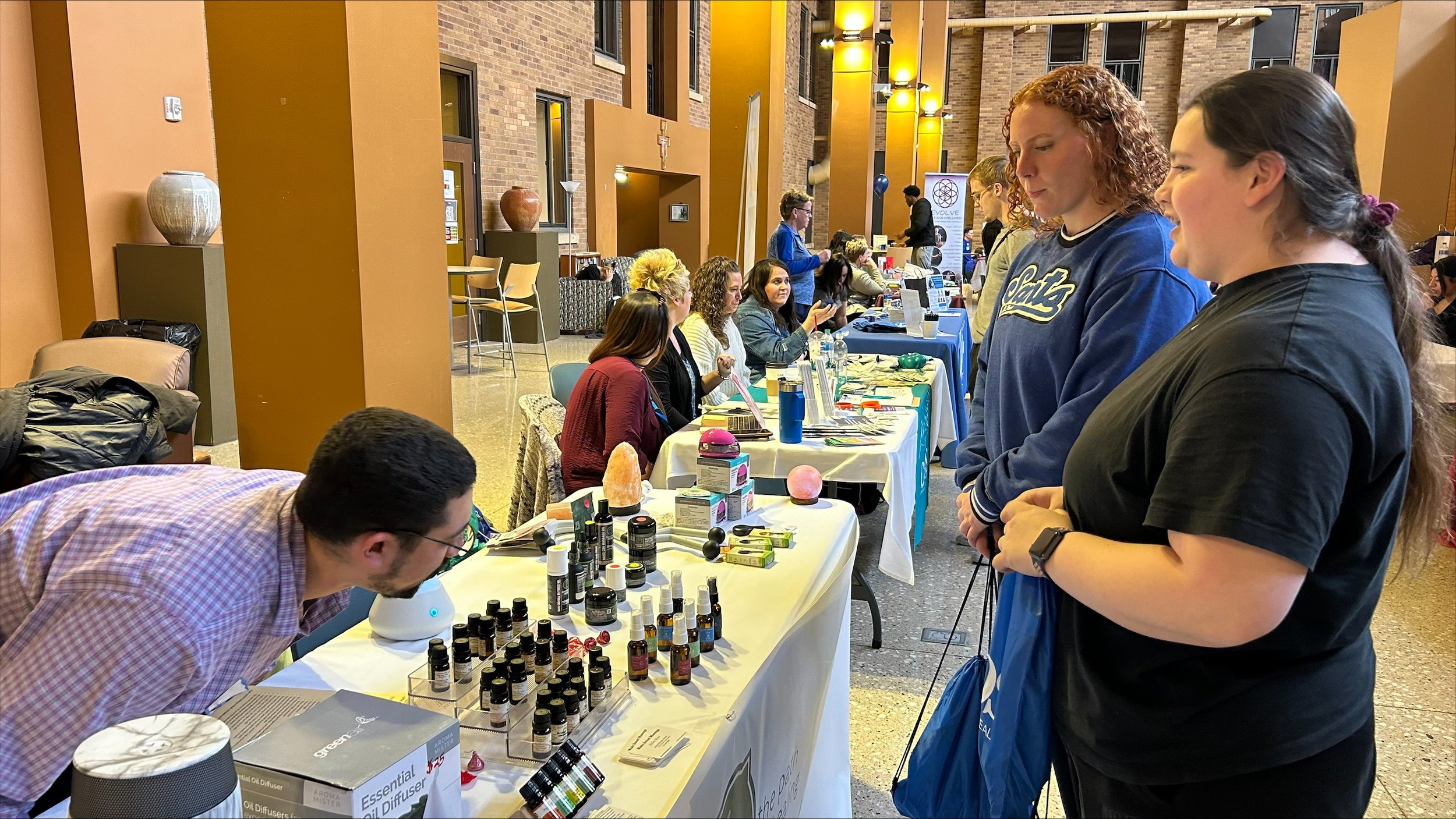  Drew from Main Street Massage and Wellness Center show BCU students Georgia Krohn and Lyndsey Mcgowan the benefits of essential oils.&nbsp; 