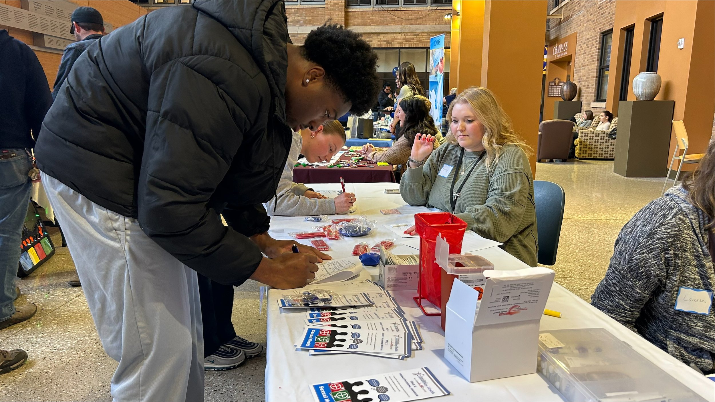  Aaron Okoro, and BCU student, signing up at the Siouxland Community Health Center booth. With the equipment they brought, participants were tested for syphilis and HIV on the spot and got their results within minutes.&nbsp; 