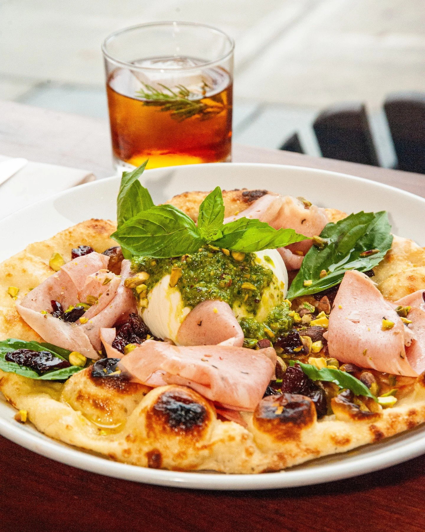 Our Winter Burrata is perfect for sharing and savoring, with mortadella, pistachio pesto, red wine soaked cherries, Corto olive oil, and basil on a Mio baked flatbread.⁠
⁠
Couple of holiday reminders! We&rsquo;re closing early on Christmas Eve at 3pm