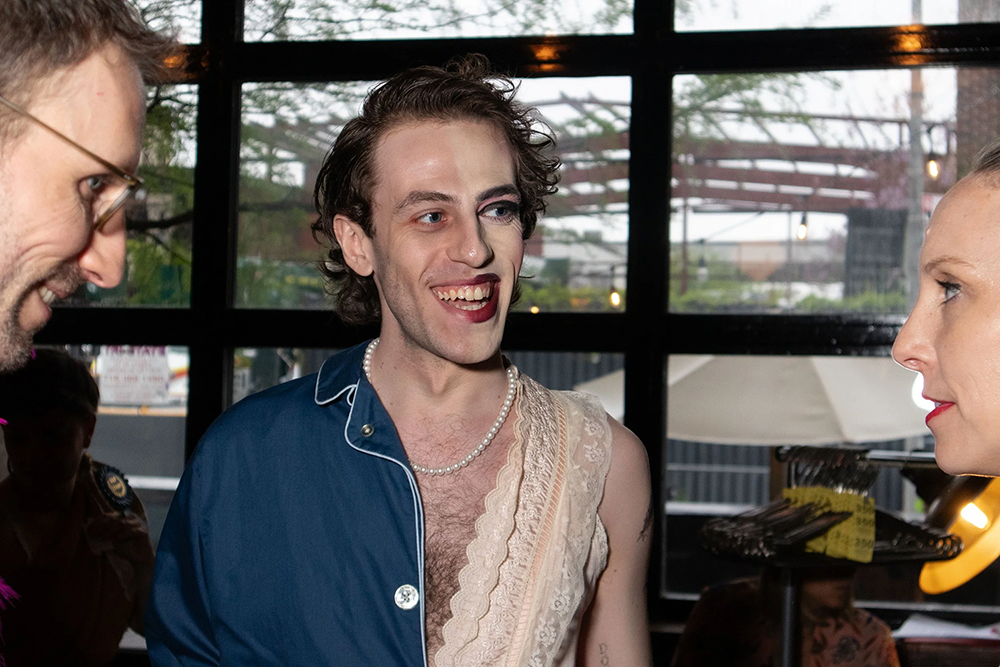 Man presenting wearing half face with makeup half without and clothes represents half masculine look and half feminine look