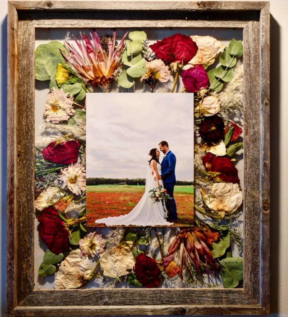 Extra large 16x20&rdquo; reclaimed barnwood frame with exotic flowers from bride&rsquo;s bouquet