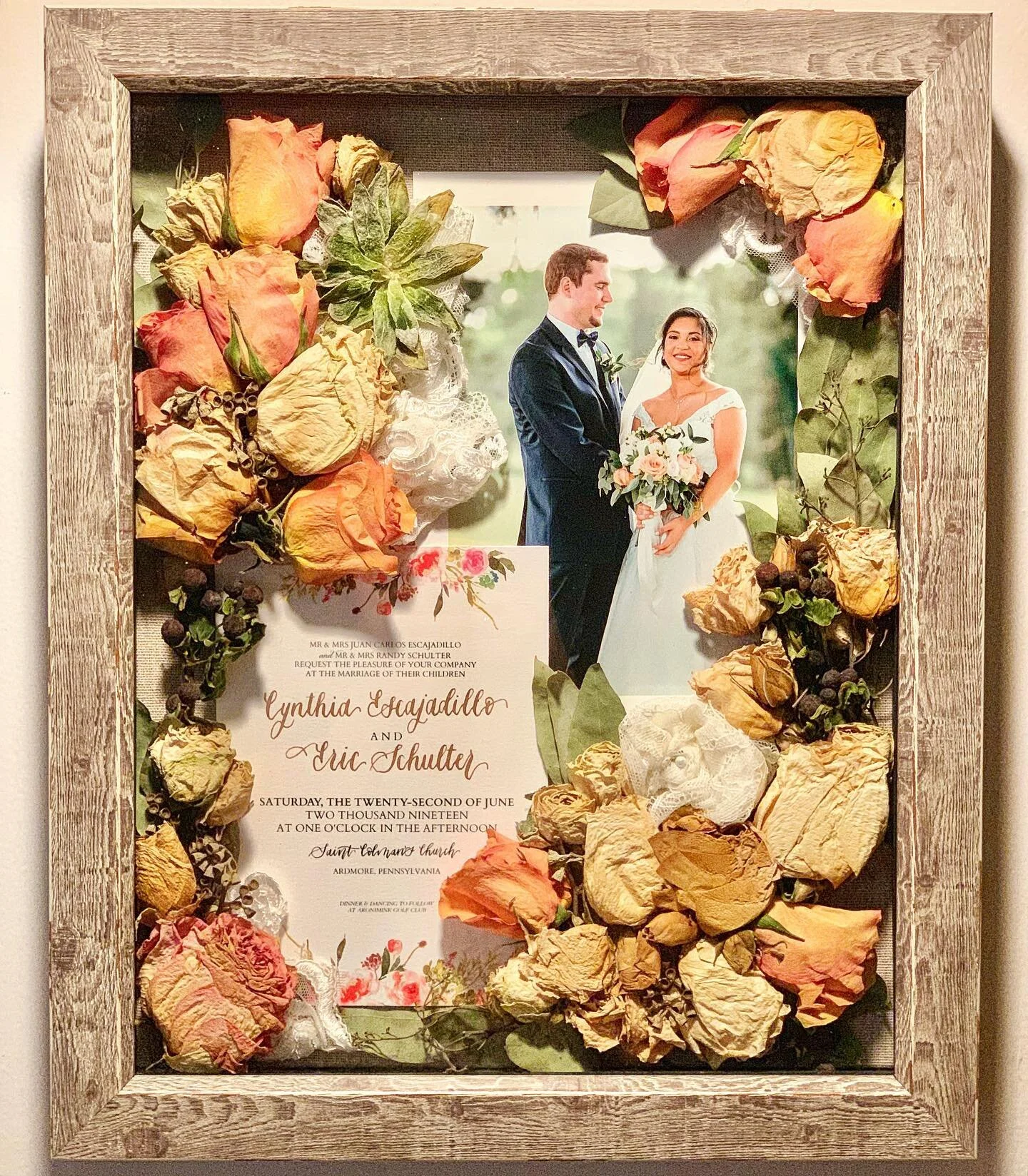 11 x 14&rdquo; shadow box including photo of bride and groom along with wedding invite, flowers and succulents from the bouquet, and lace from bride&rsquo;s dress.