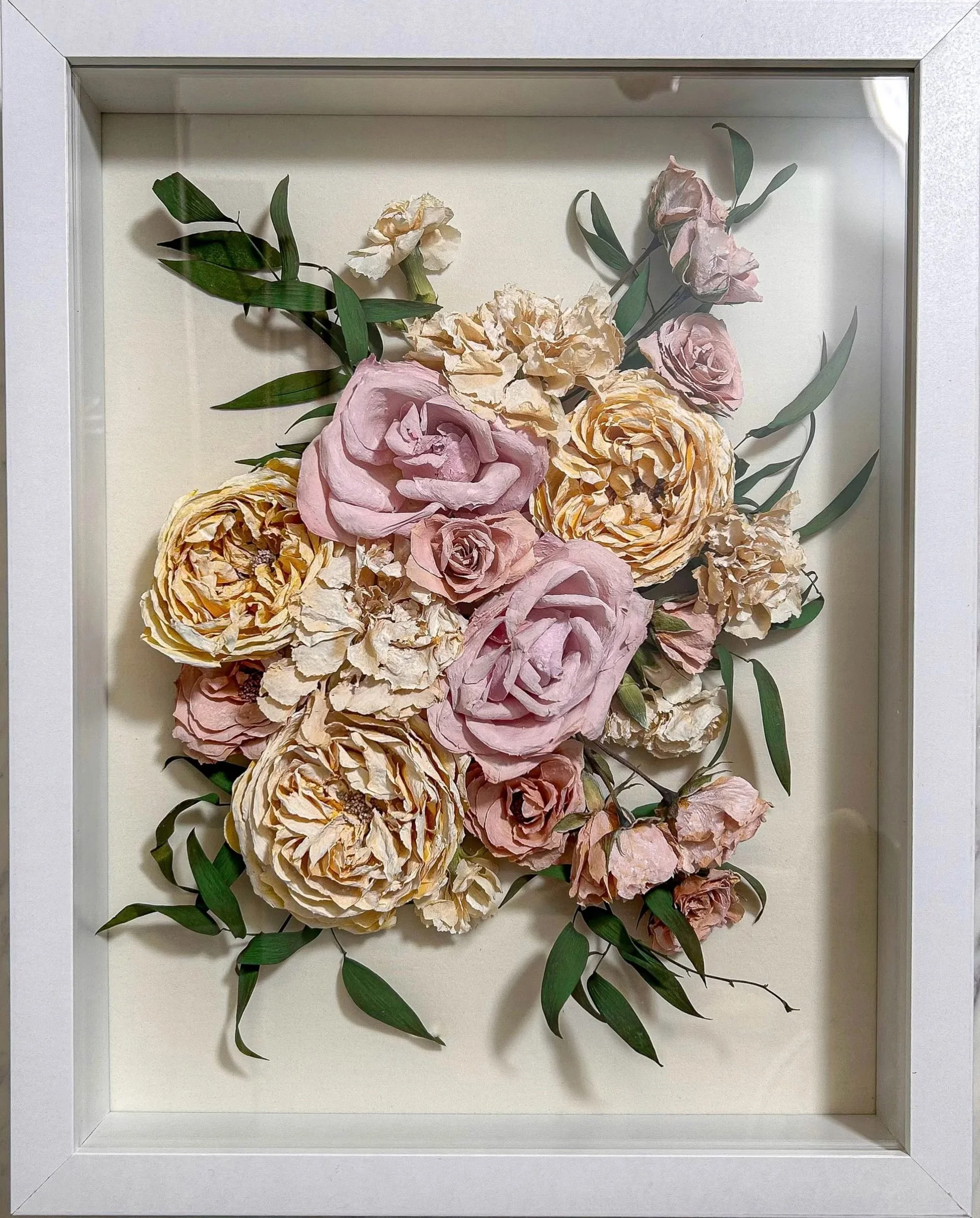 11x14 white shadow box with white background featuring color corrected roes and carnations. 