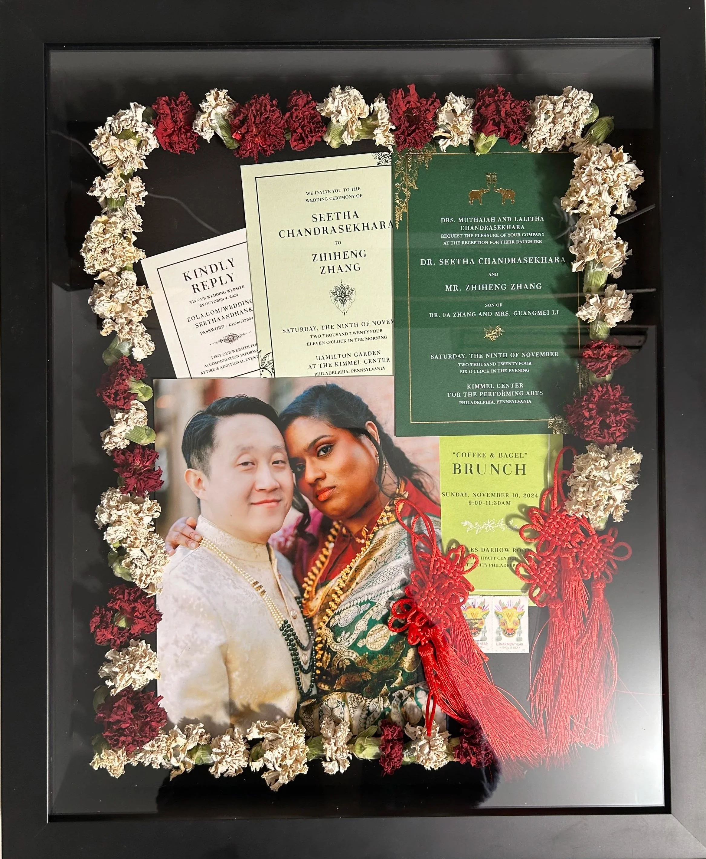 16x20 custom black shadowbox with black backing featuring 8x10 photo of couple along with invitation, RSVP card, stamps from envelopes, color corrected florals and Chinese knots. 
