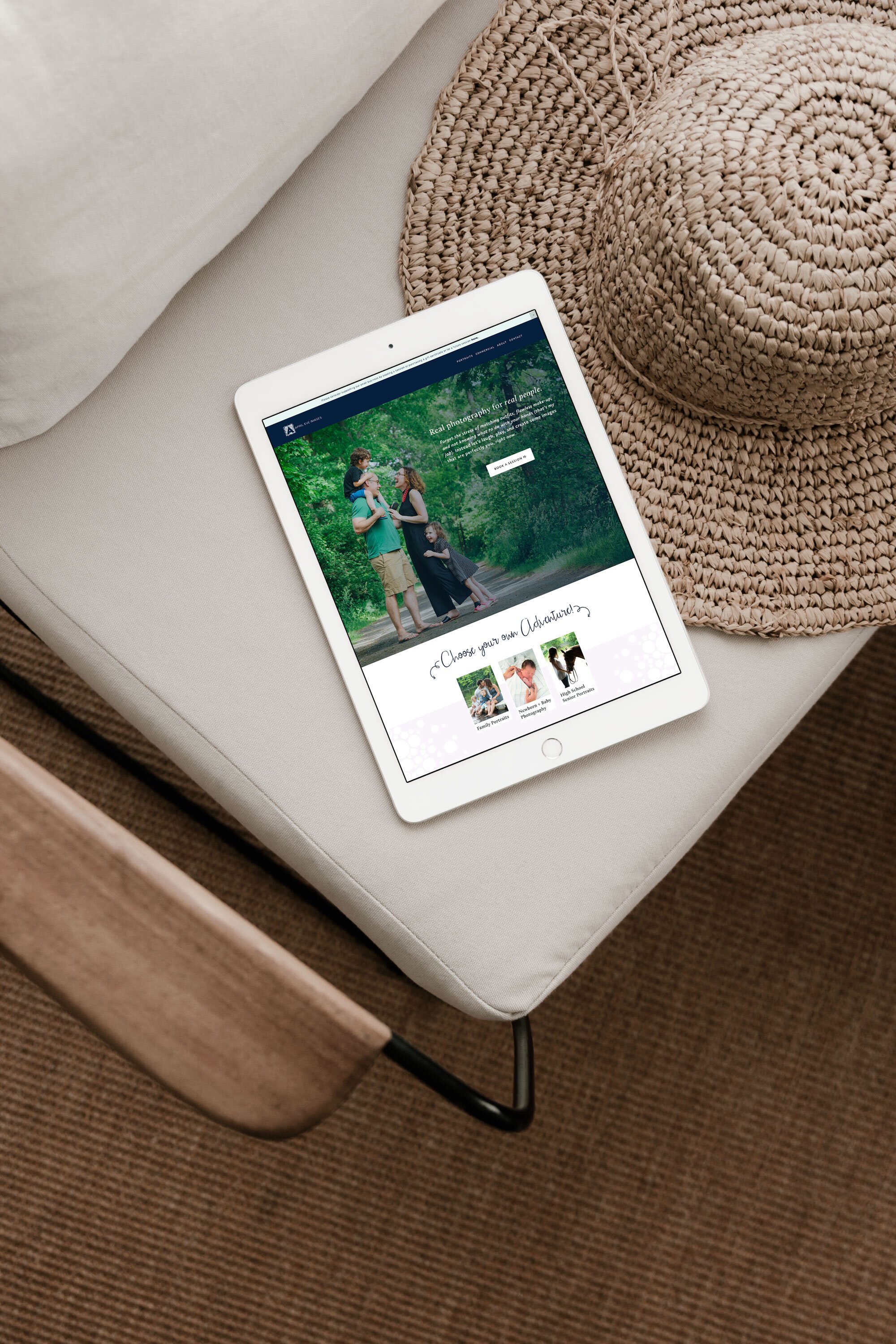  custom website design for the business of a local portrait photographer based in Massachusetts. The website shows a portrait of a happy family in a forest and a section beneath outlining services. The website design is displayed on an iPad. The iPad