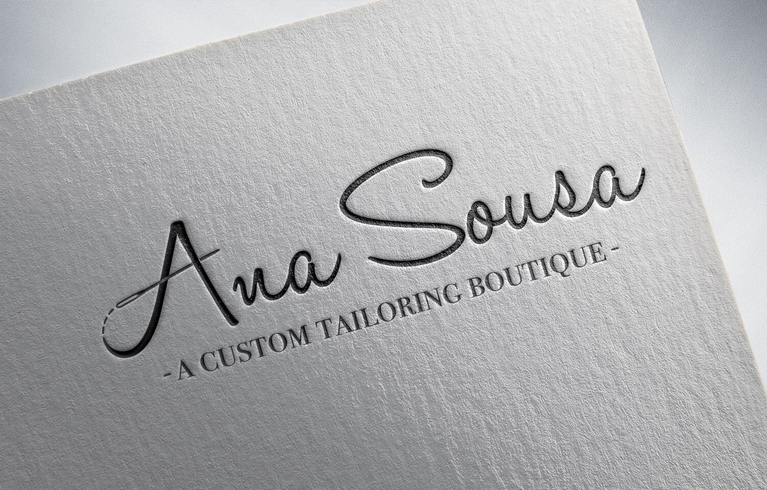  A custom logo design for Ana Sousa, a Custom Tailoring Boutique in a hand lettered font with the cross of the A appearing like stitches and a sewing needle threading it to form the capital letter A. 