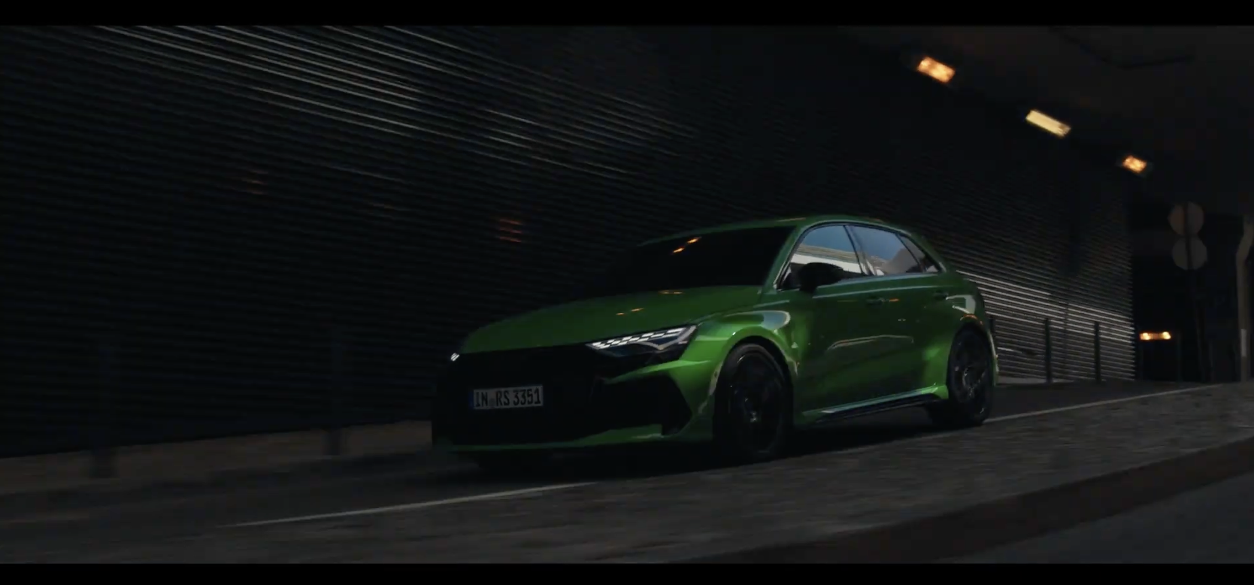 A green sports car driving through a tunnel at night.