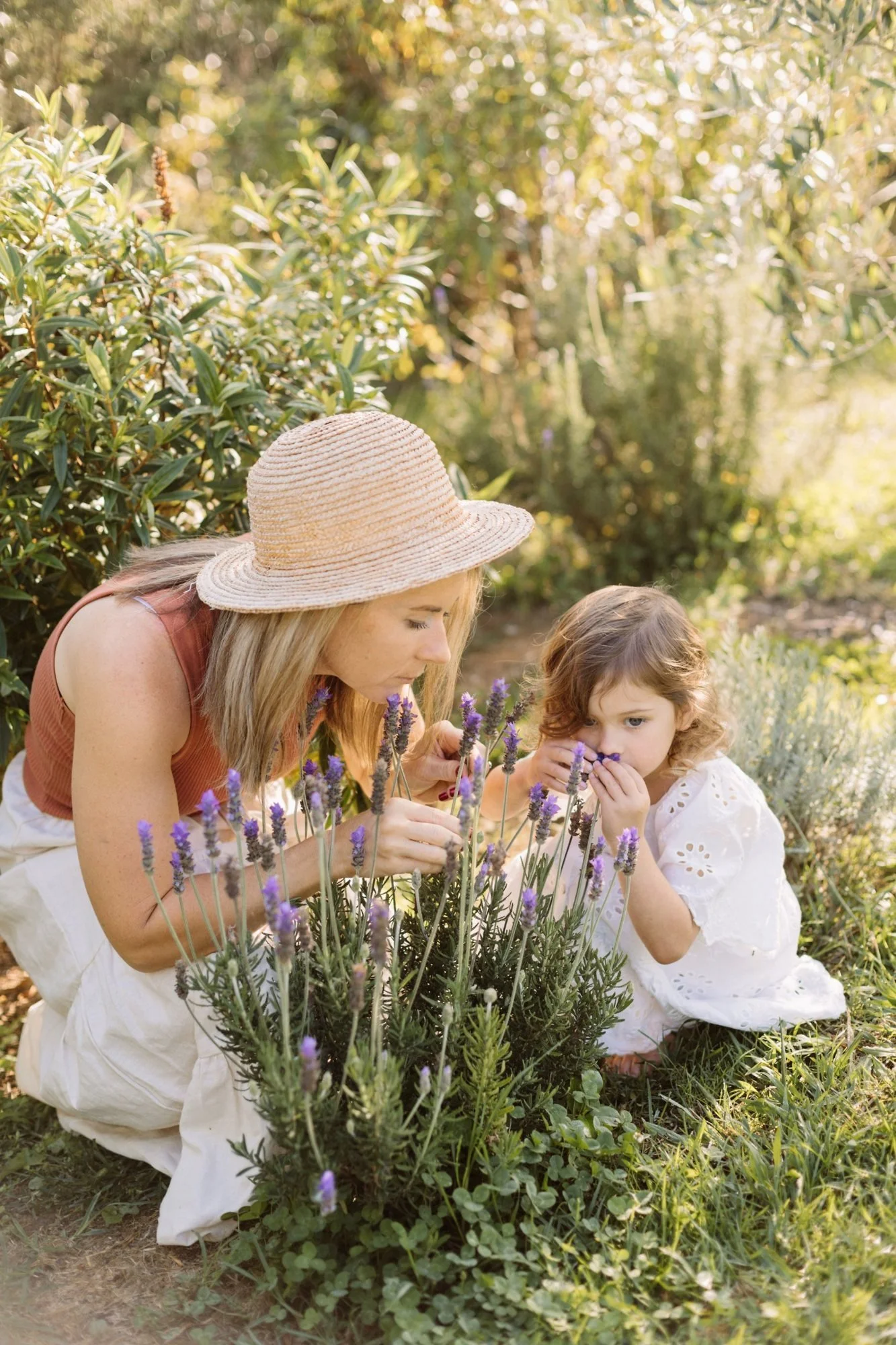 Kirstie and her daughter smelling lavender in the garden