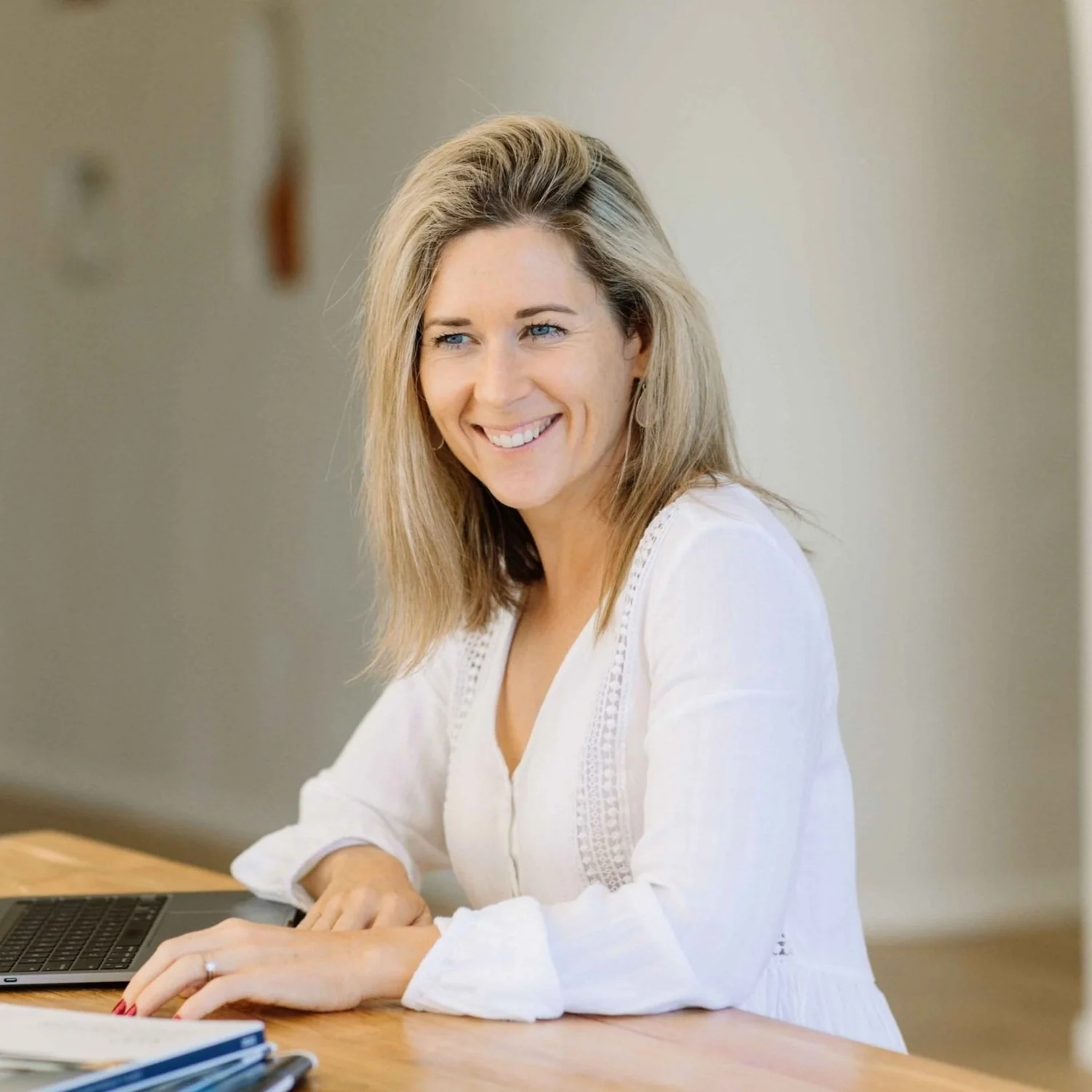 Kirstie Vesseur seated in white, smiling
