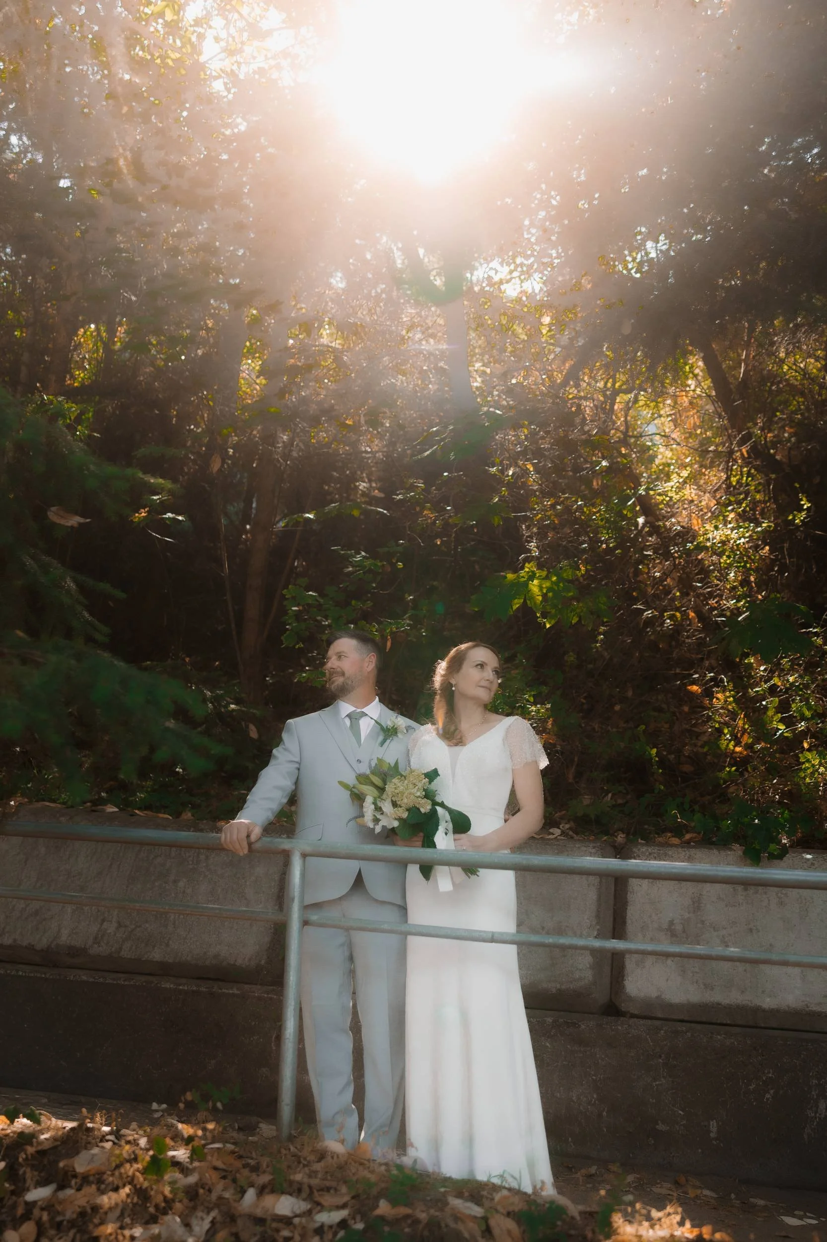 Newlyweds photographed along a forest path at Tigh-Na-Mara in Parksville