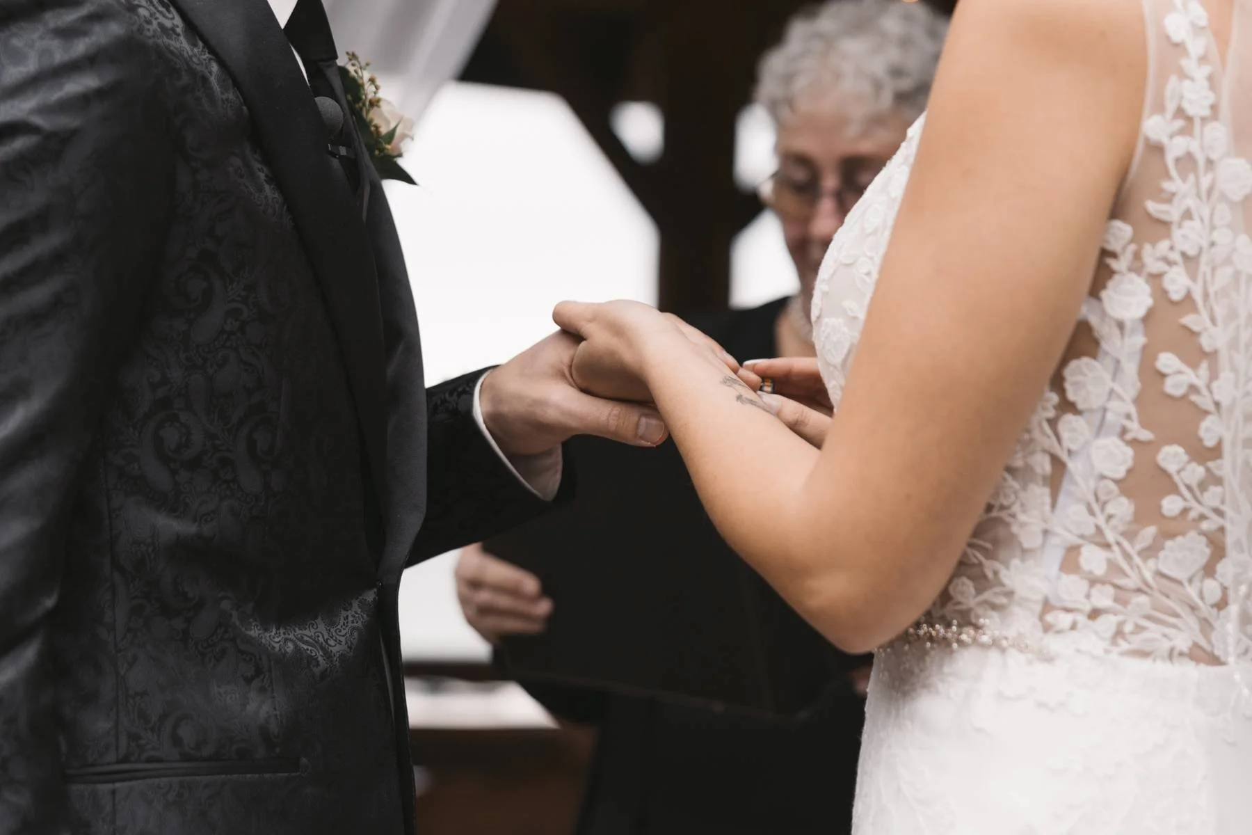Bride placing a wedding ring on groom’s hand during a ceremony at Tigh-Na-Mara Seaside Spa Resort in Parksville, British Columbia