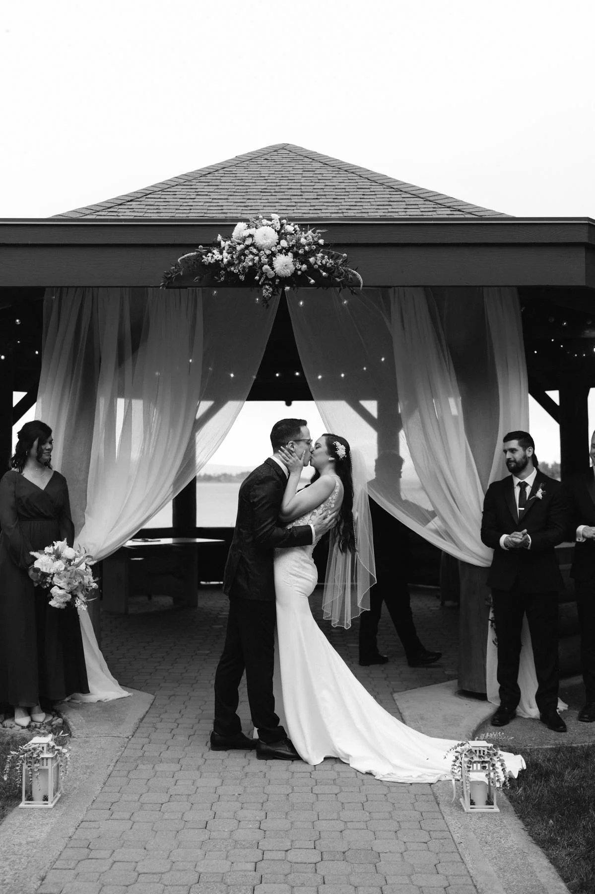 Bride and groom sharing their first kiss at an oceanfront wedding ceremony at Tigh-Na-Mara Seaside Spa Resort in Parksville, British Columbia