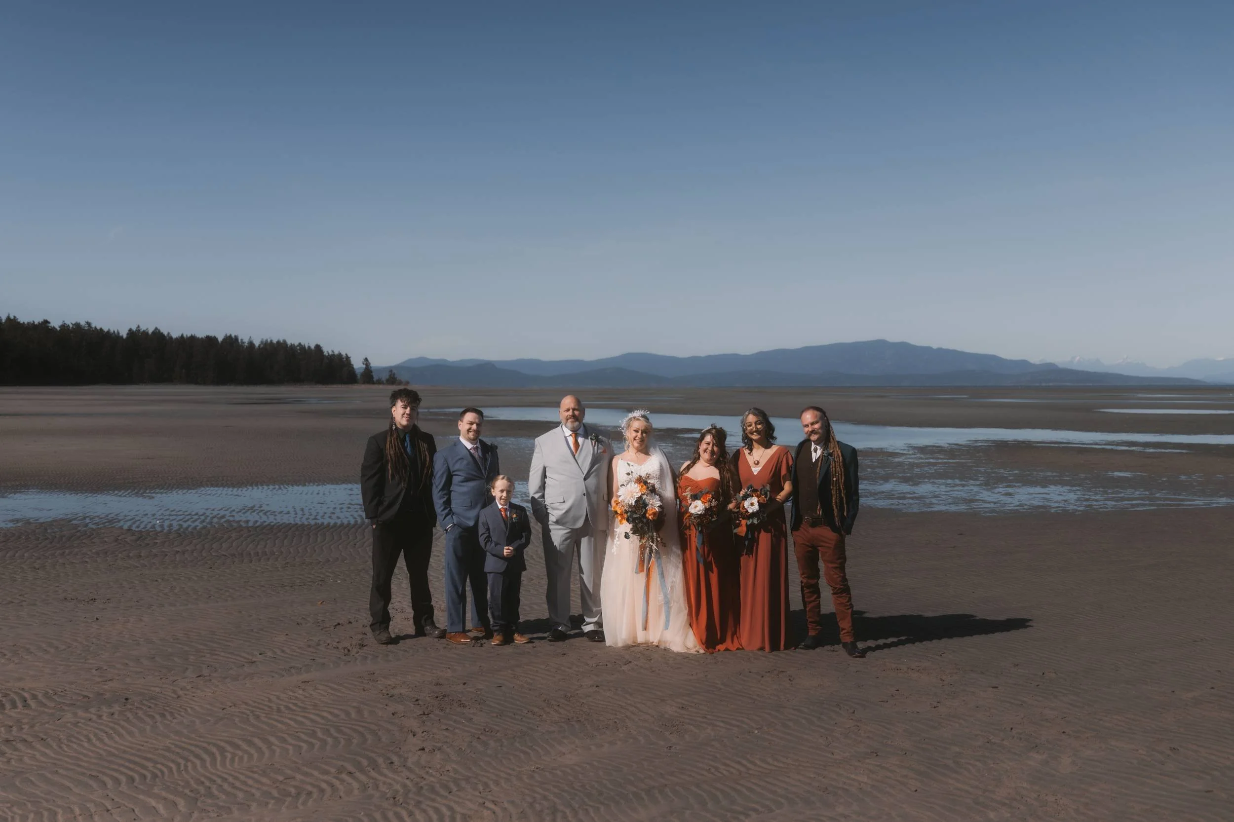 Wedding party photographed on the beach at low tide near Tigh-Na-Mara in Parksville