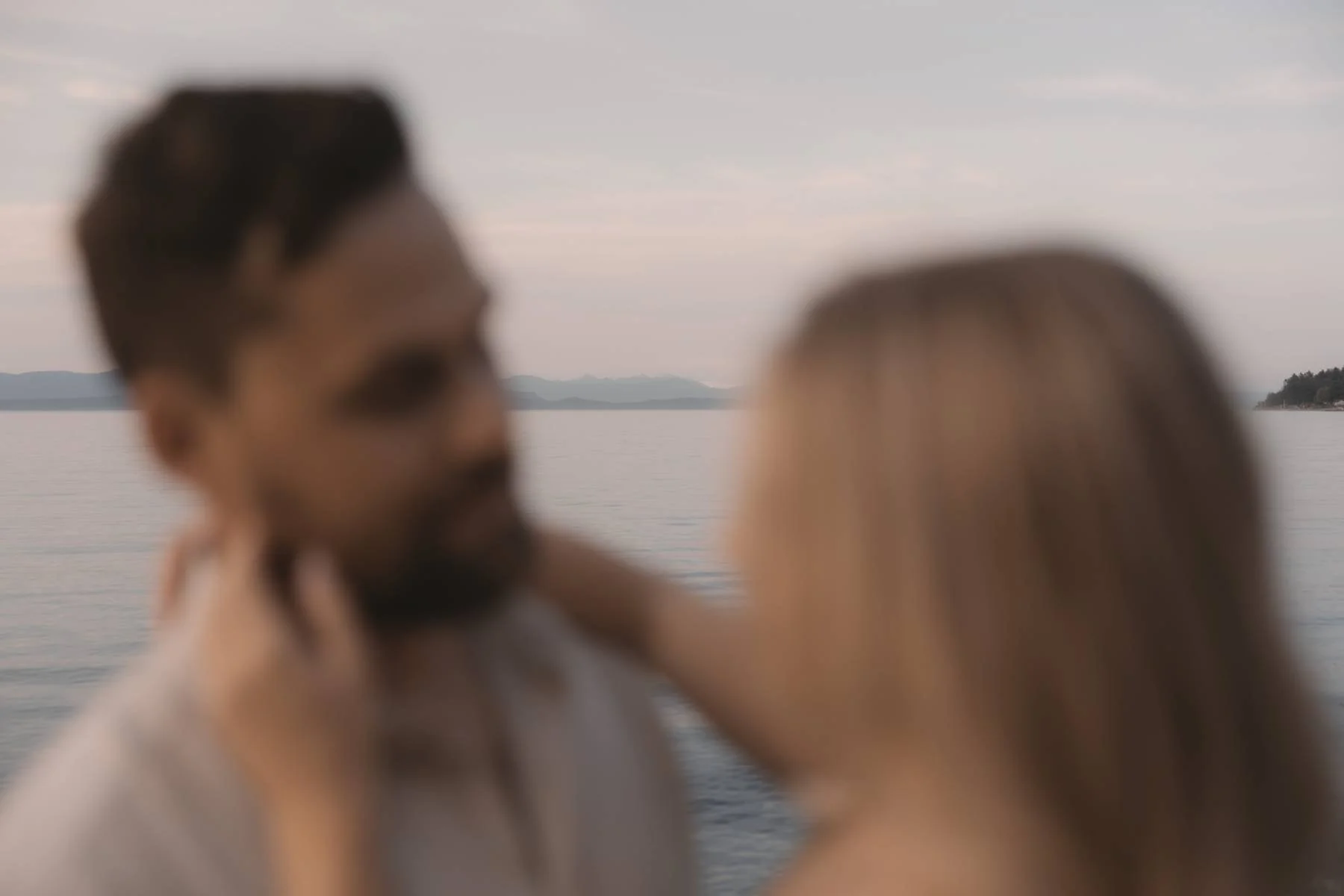 Romantic sunset couple portrait along the ocean in Qualicum Beach near Parksville on Vancouver Island