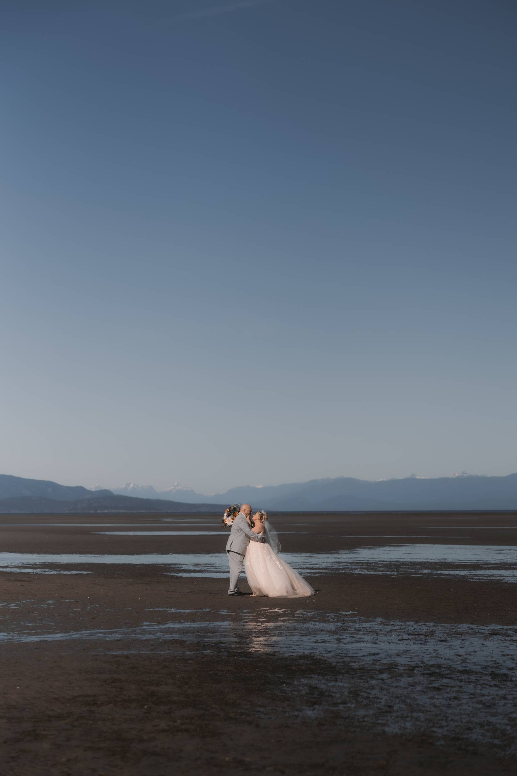 Couple sharing a quiet wedding portrait on the beach near Tigh-Na-Mara in Parksville