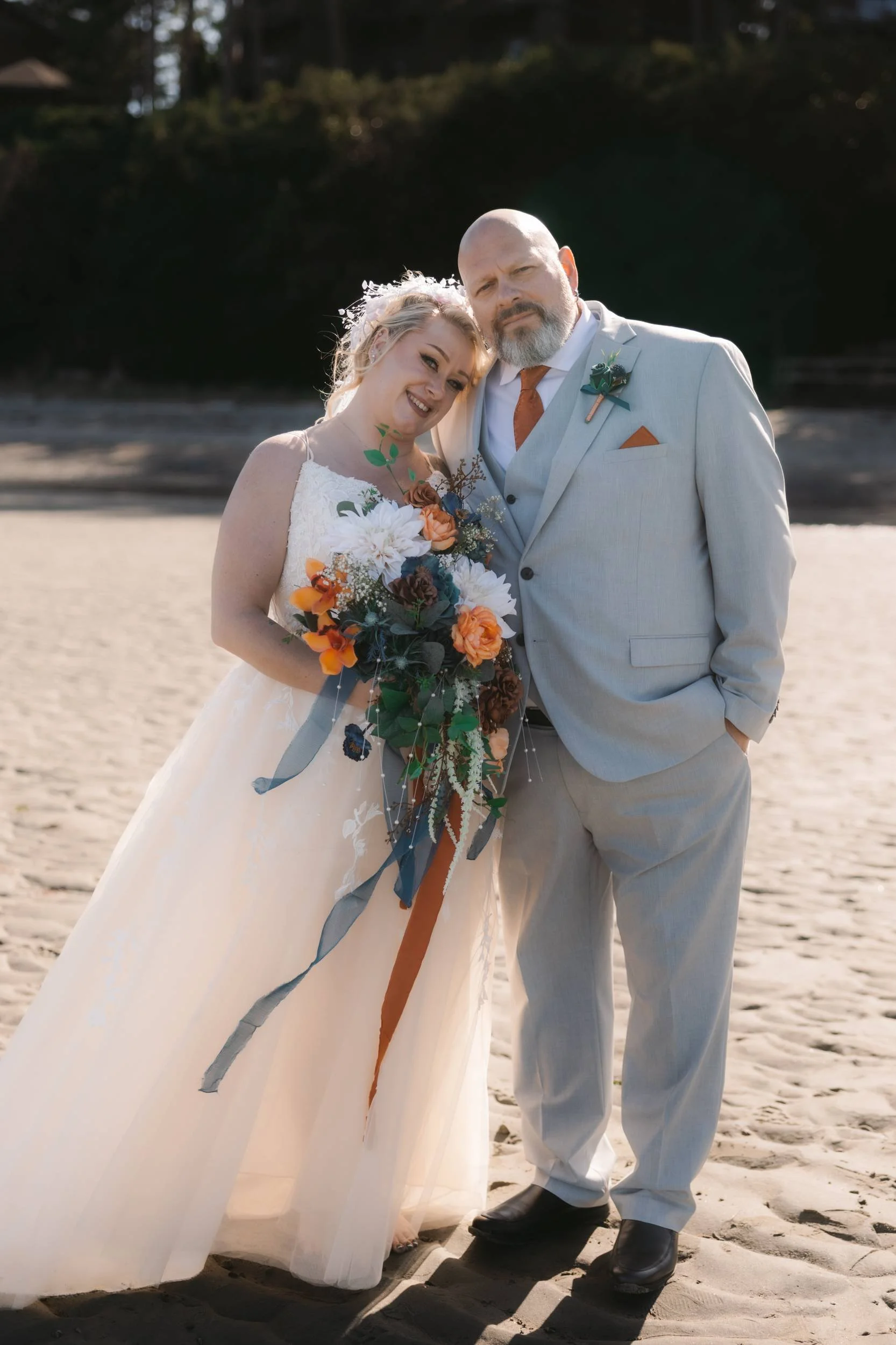 Relaxed newlywed portrait on the beach near Tigh-Na-Mara in Parksville, BC