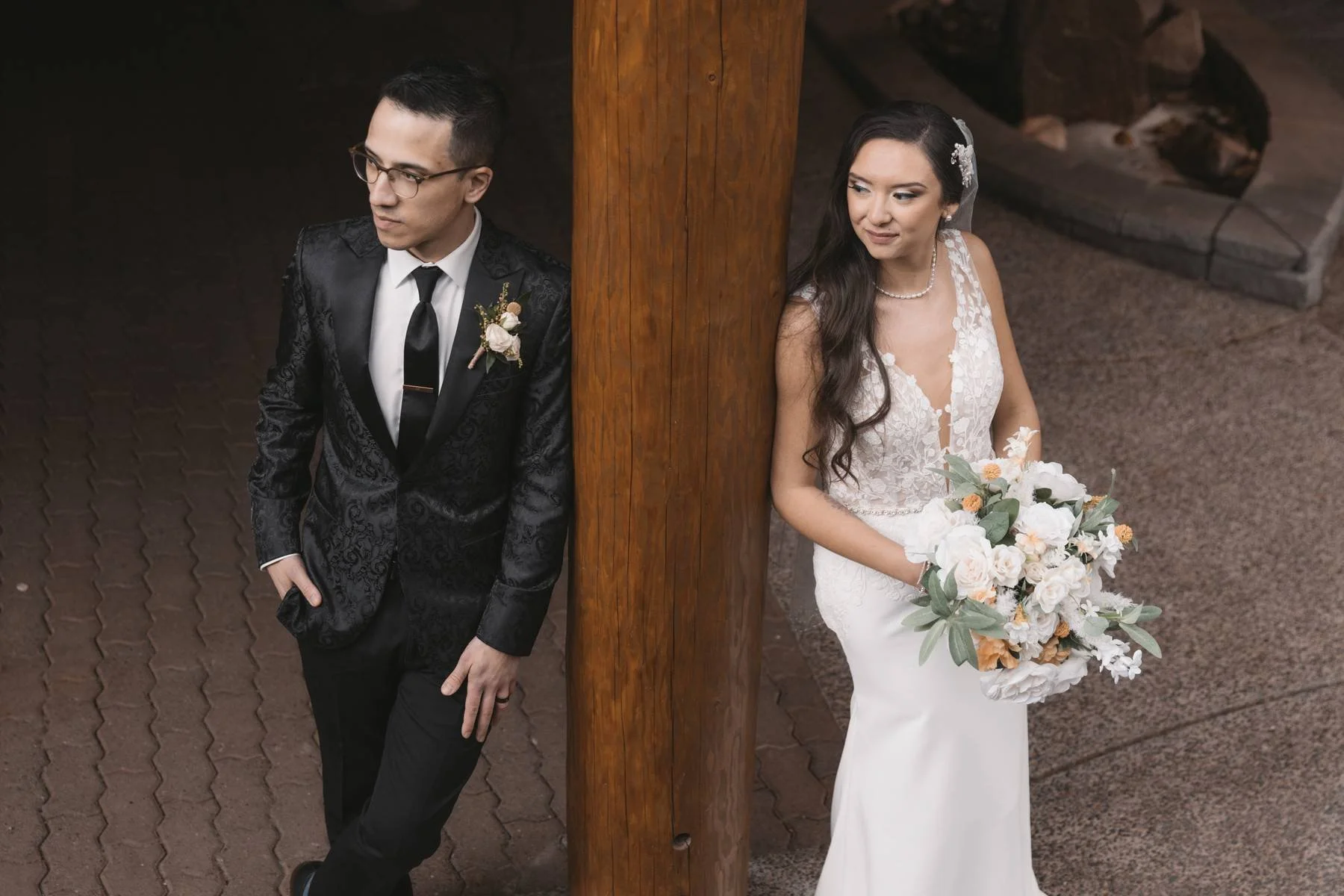 Bride and groom portrait beside wooden pillars at Tigh-Na-Mara Seaside Spa Resort wedding venue in Parksville BC