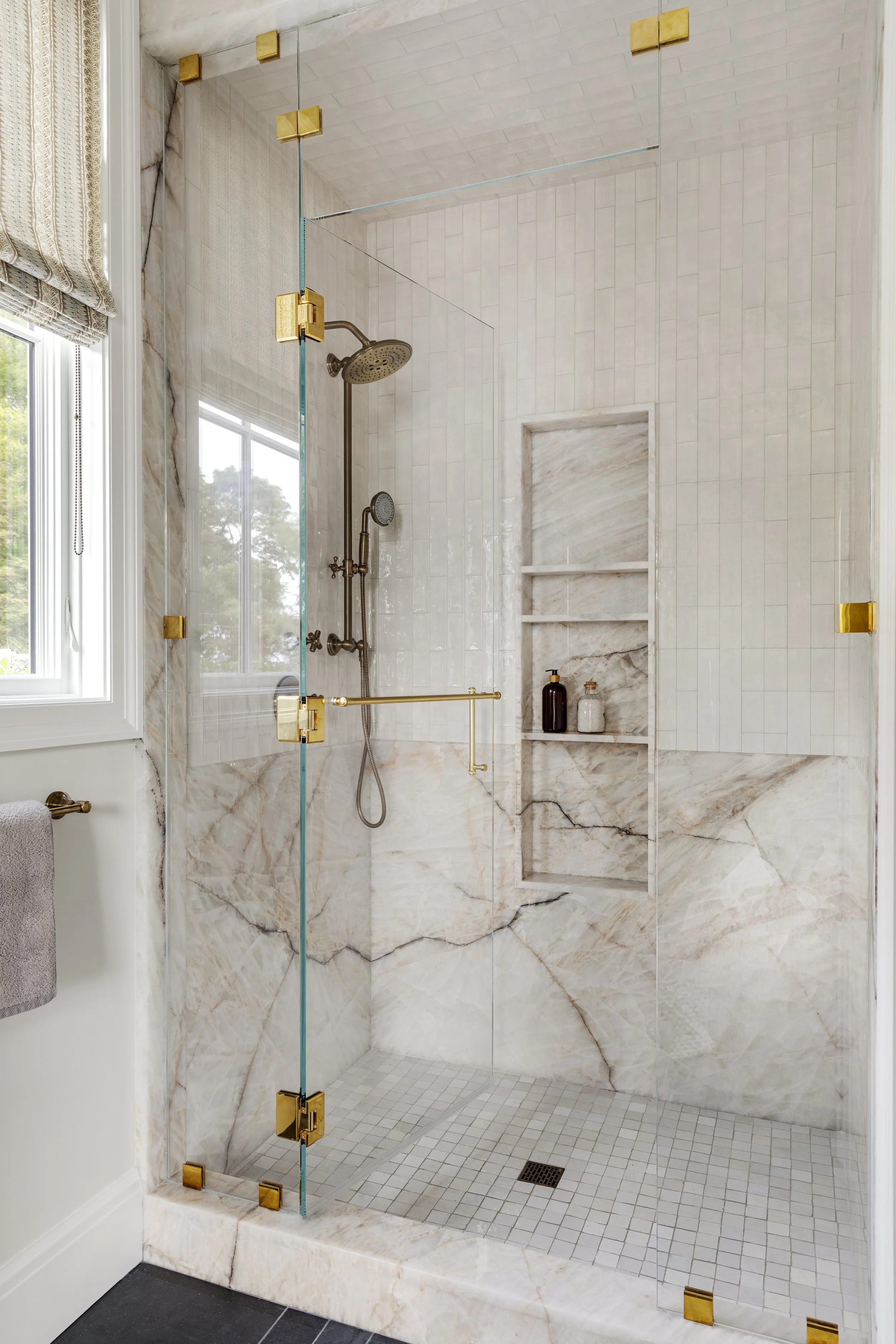 luxury-walk-in-shower-marble-tile-brass-fixtures.jpg