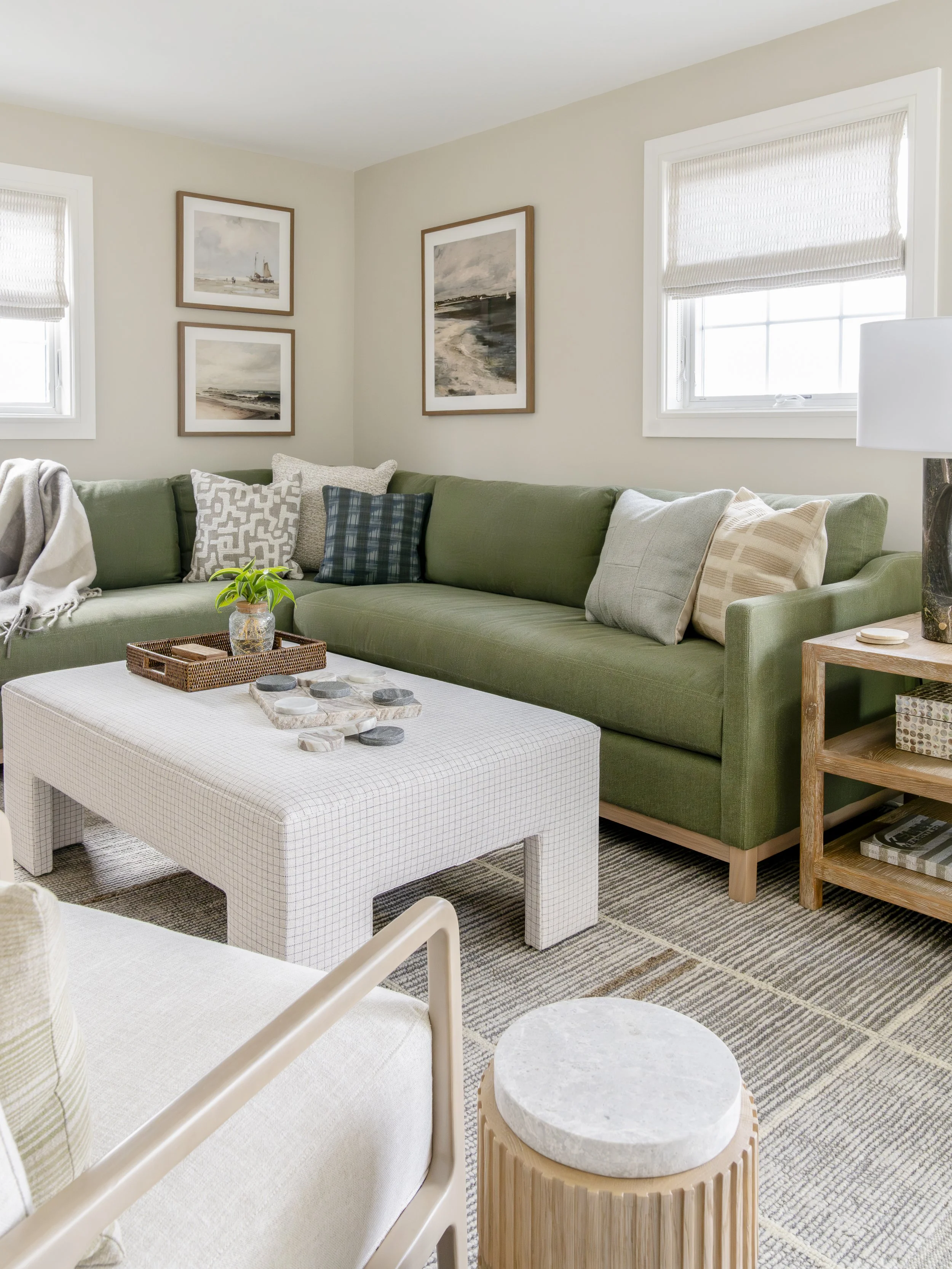 Green lounge with layered textiles and natural wood accents in the Jerusalem Heights beach house in Narragansett, Rhode Island.