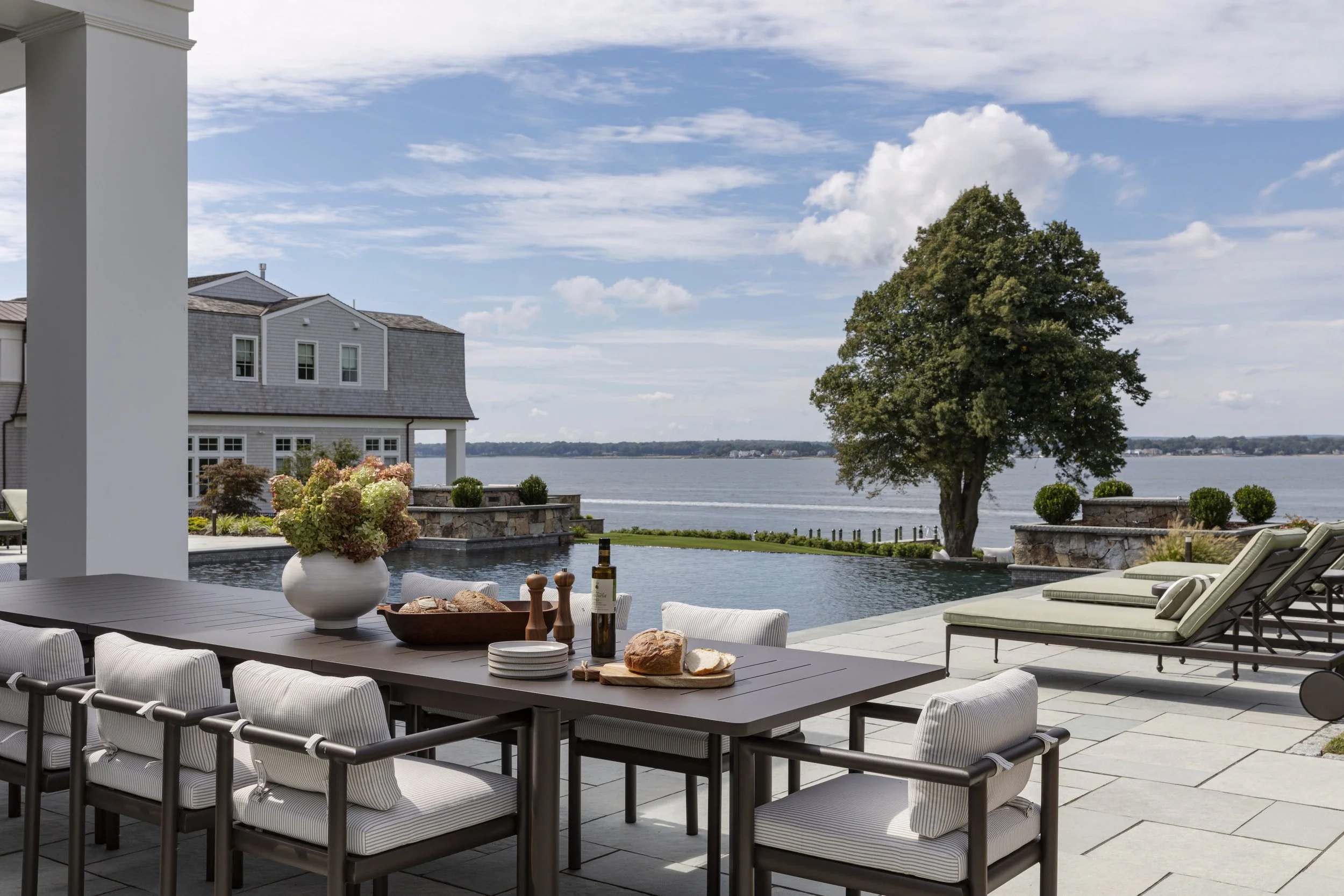 waterfront-pool-house-outdoor-dining-and-pool.jpg