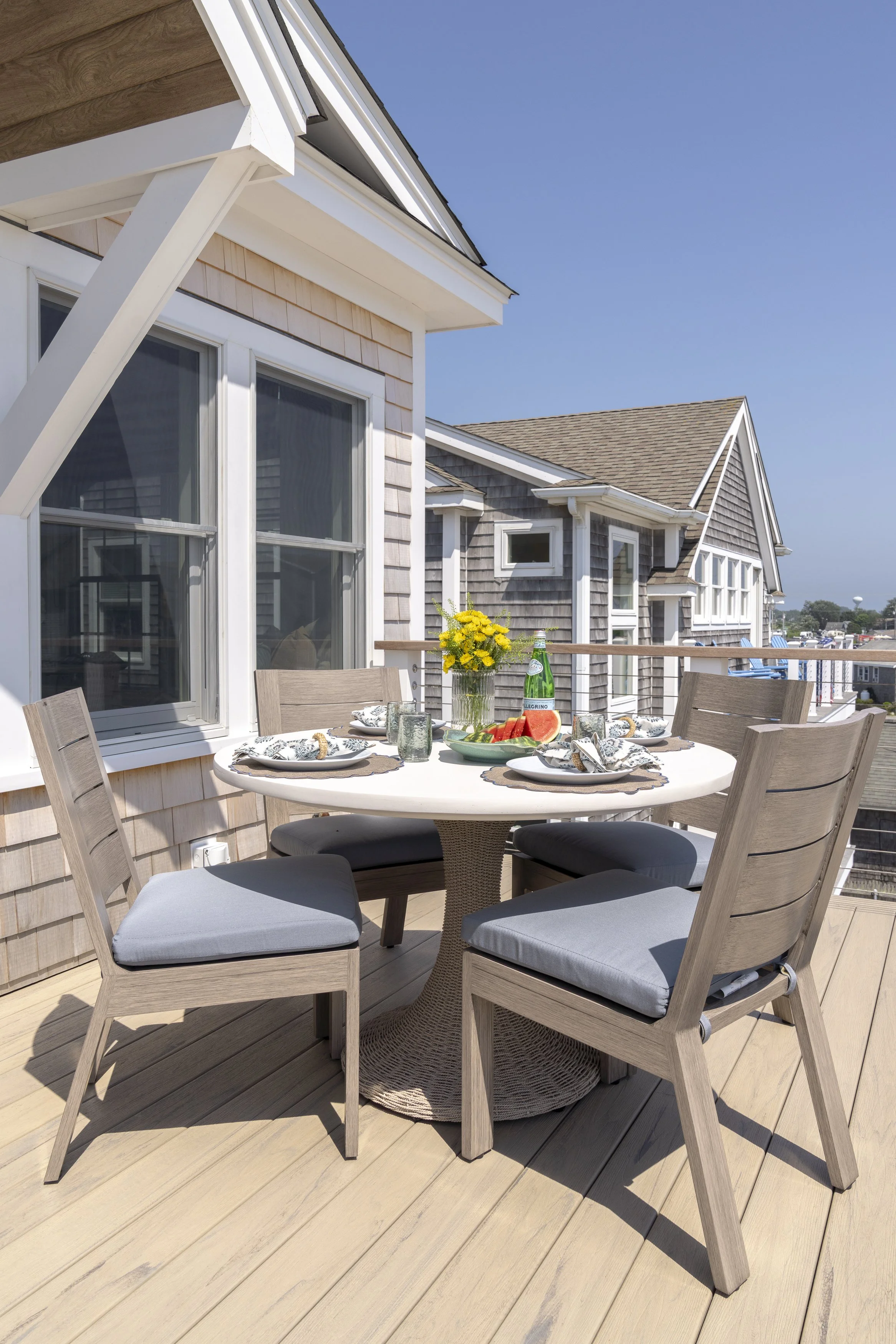 Outdoor dining deck overlooking the Rhode Island coast at an East Matunuck beach house in Narragansett.