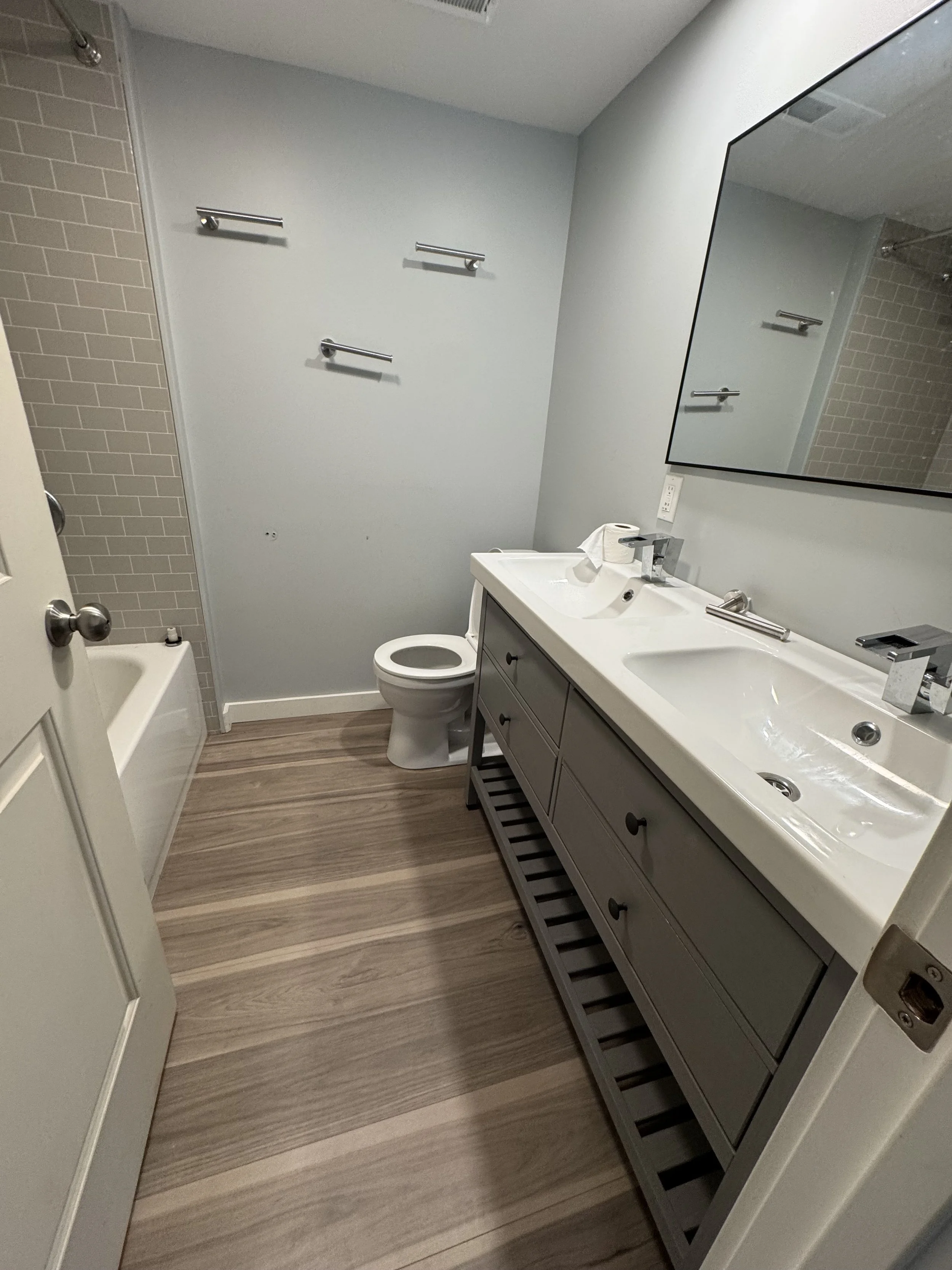 Renovated bath with tub &amp; double sinks