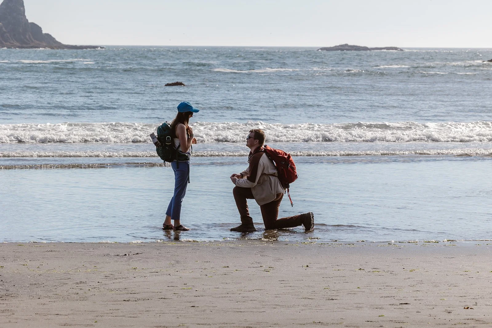 man on one knee after proposing with their engagement ring