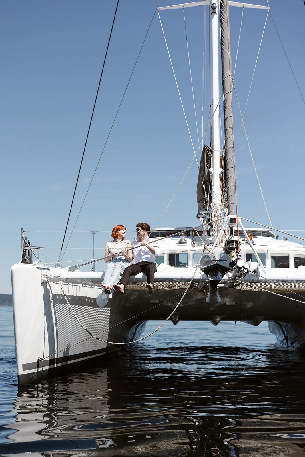  elopement couple sitting on a sailboat for their elopement