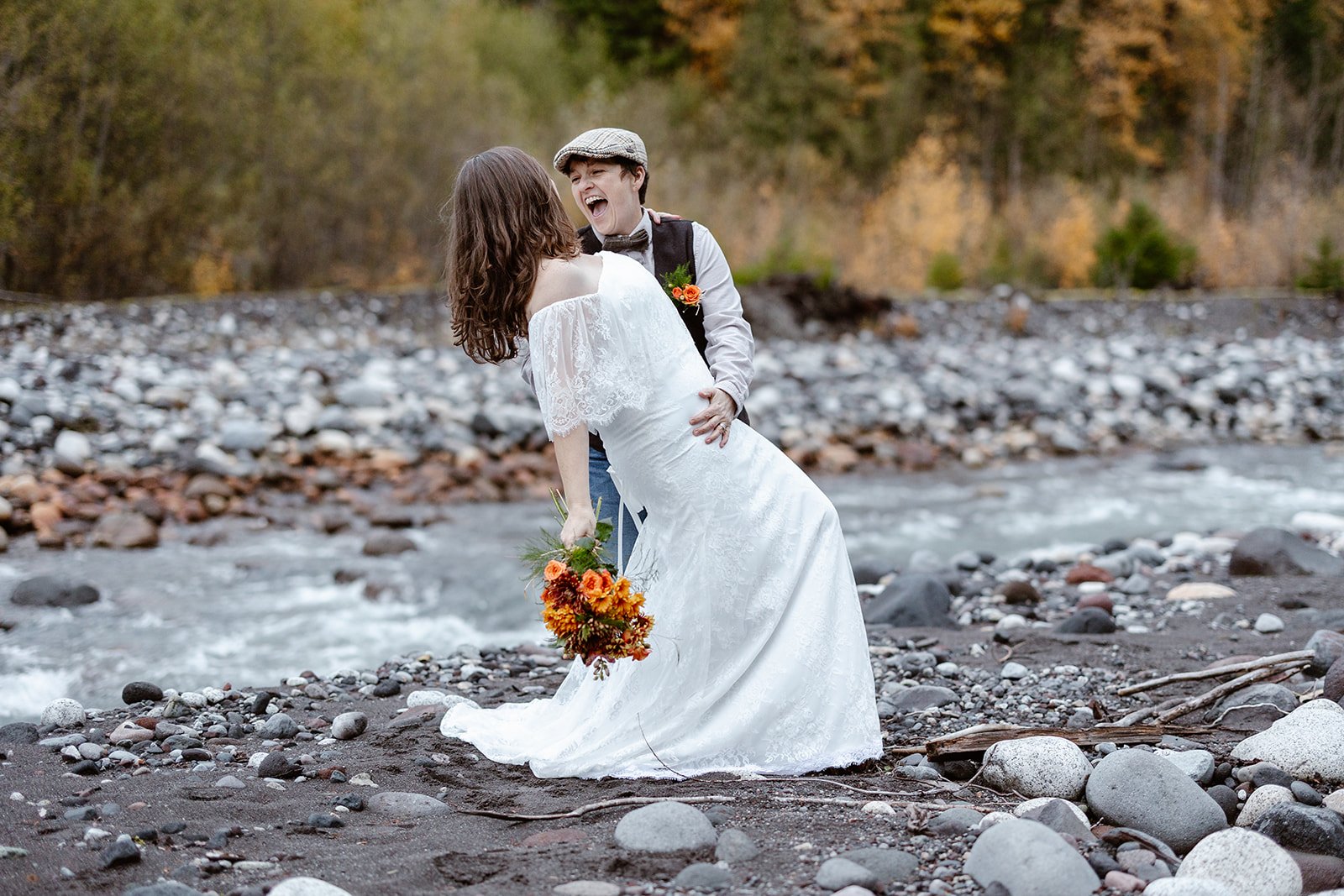 washington elopement couple doing a dip kiss and smiling at the camera
