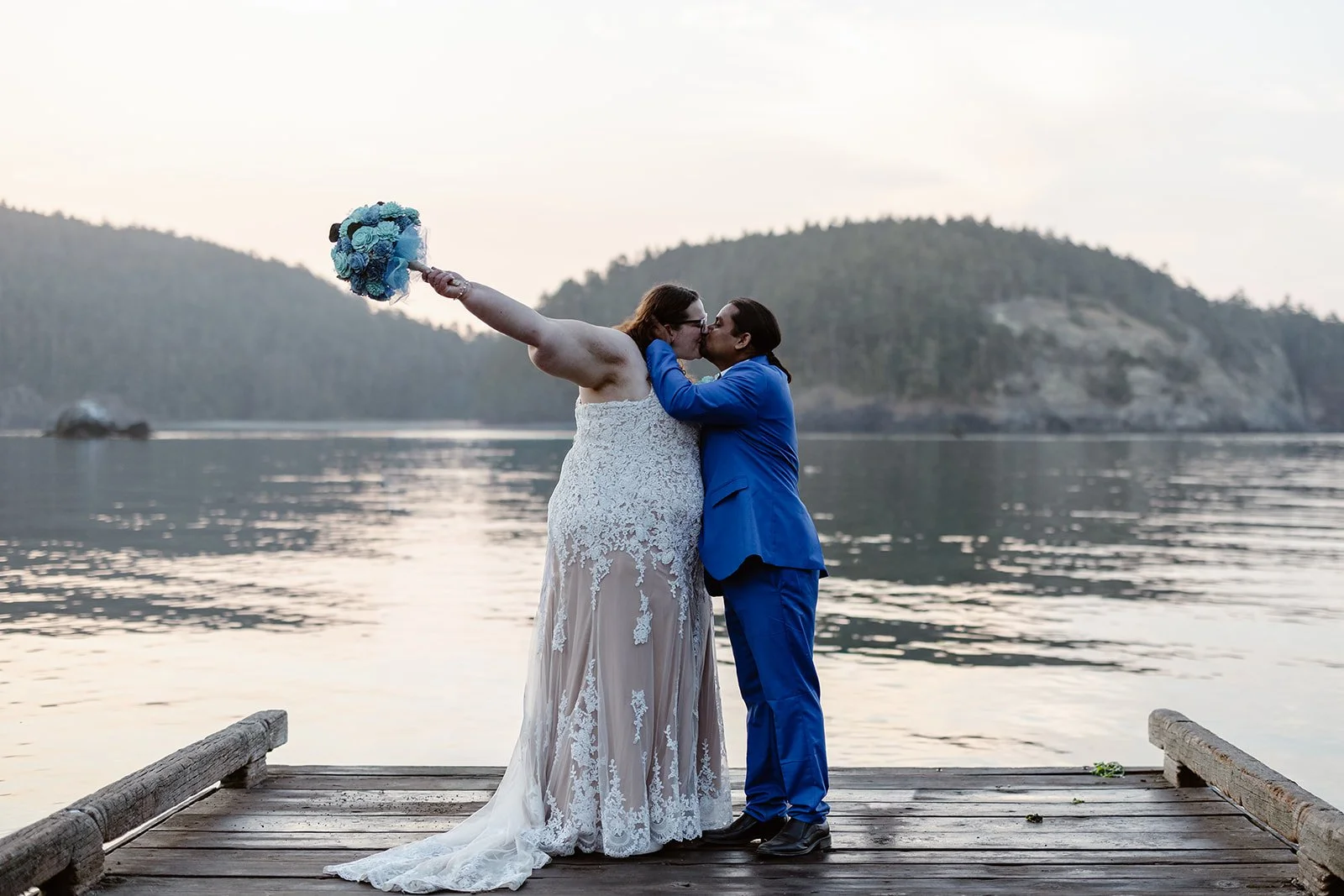 wedding couple kissing by the pier at deception pass state park