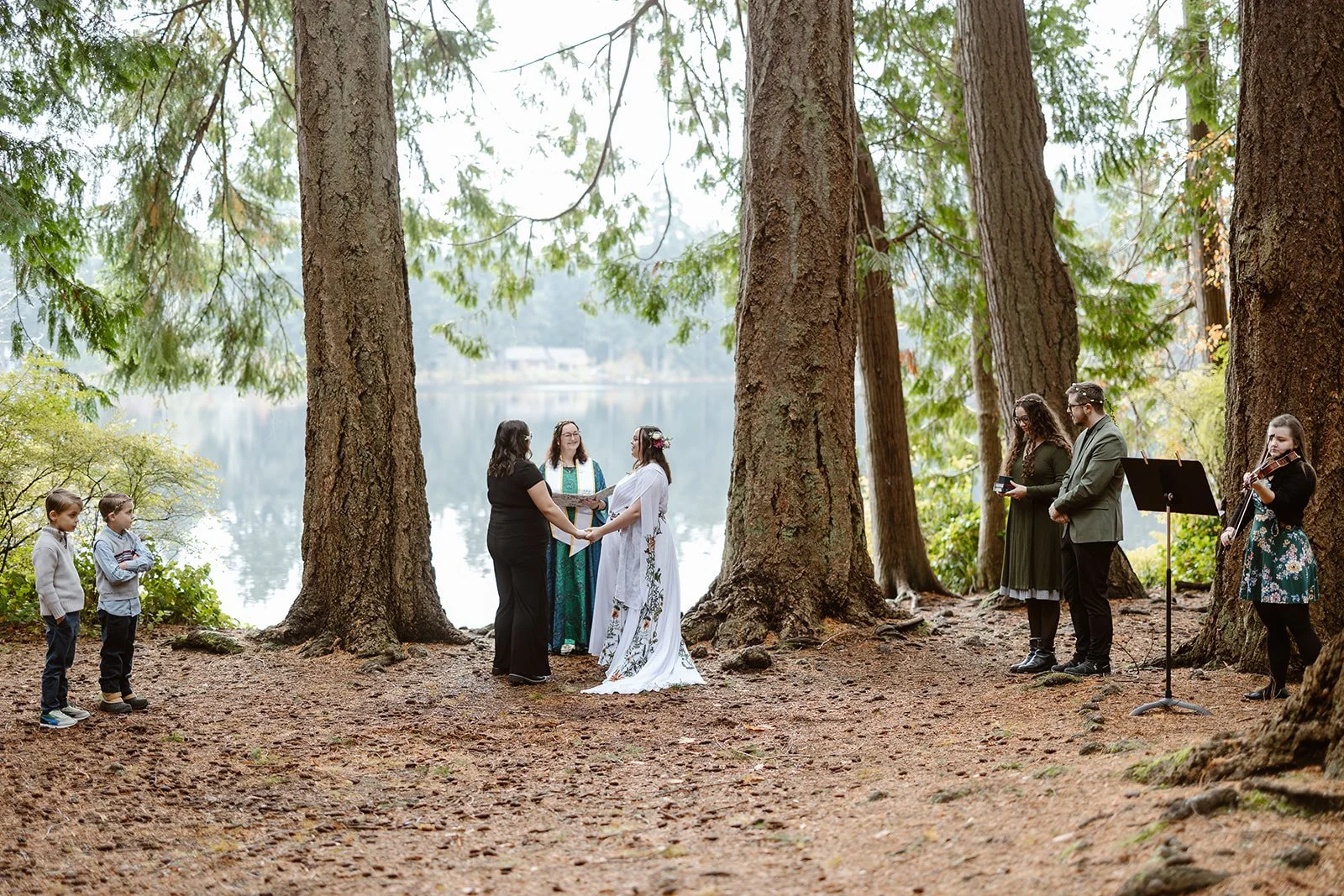 elopement couple smiling at each other for their forest elopement in washington