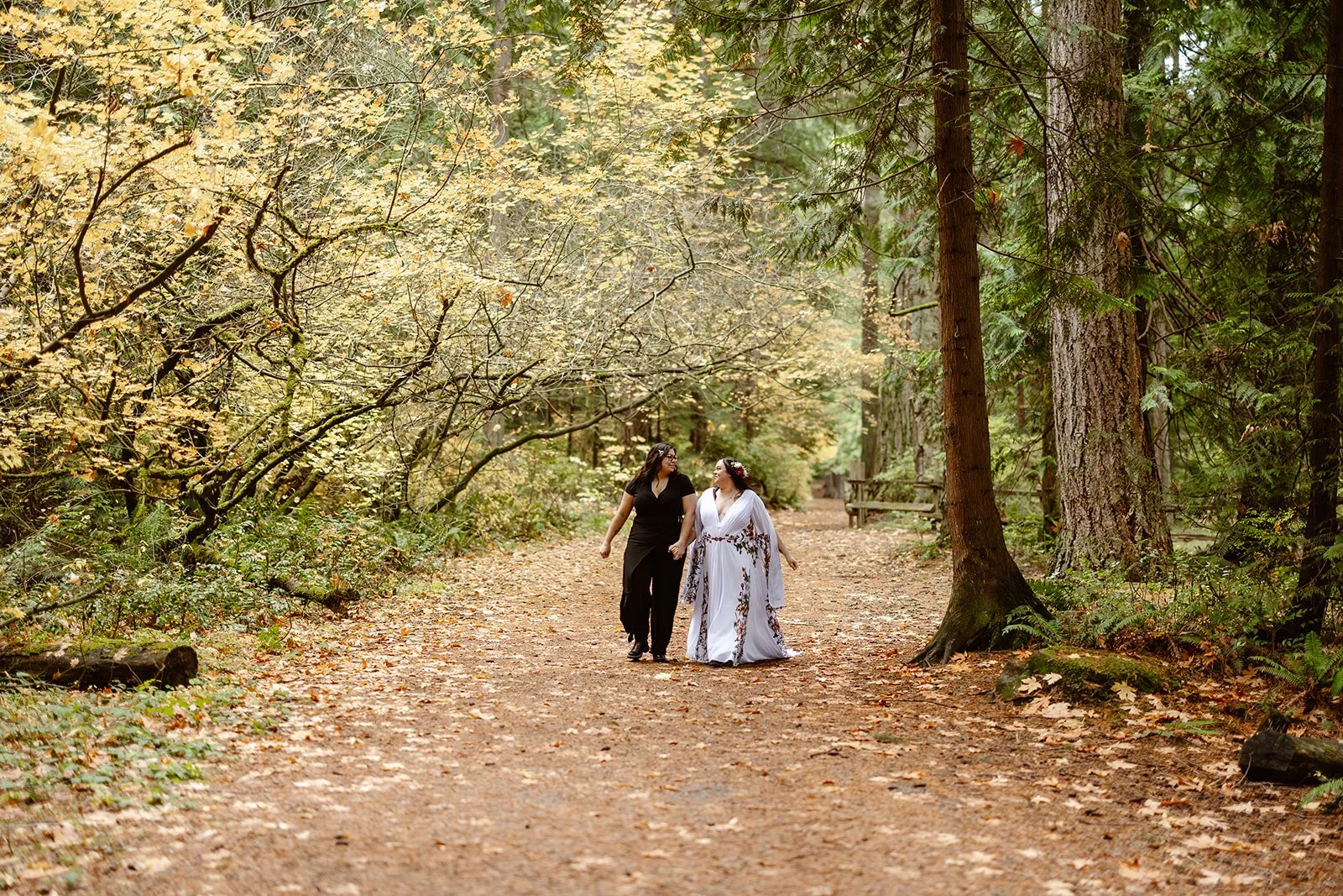 elopement couple walking along the forest for their forest elopement