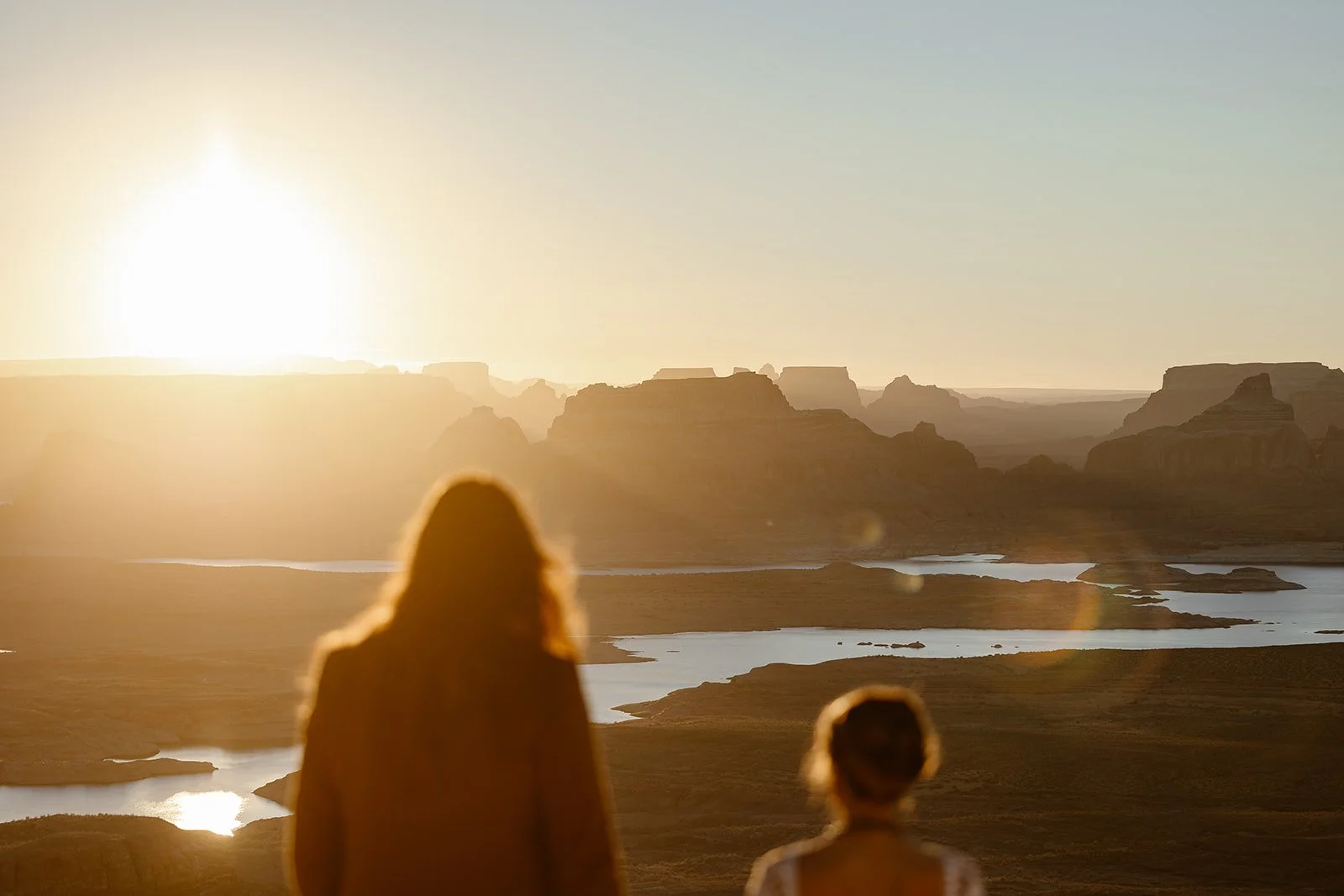 elopement couple looking at lake powell during their sunrise elopement