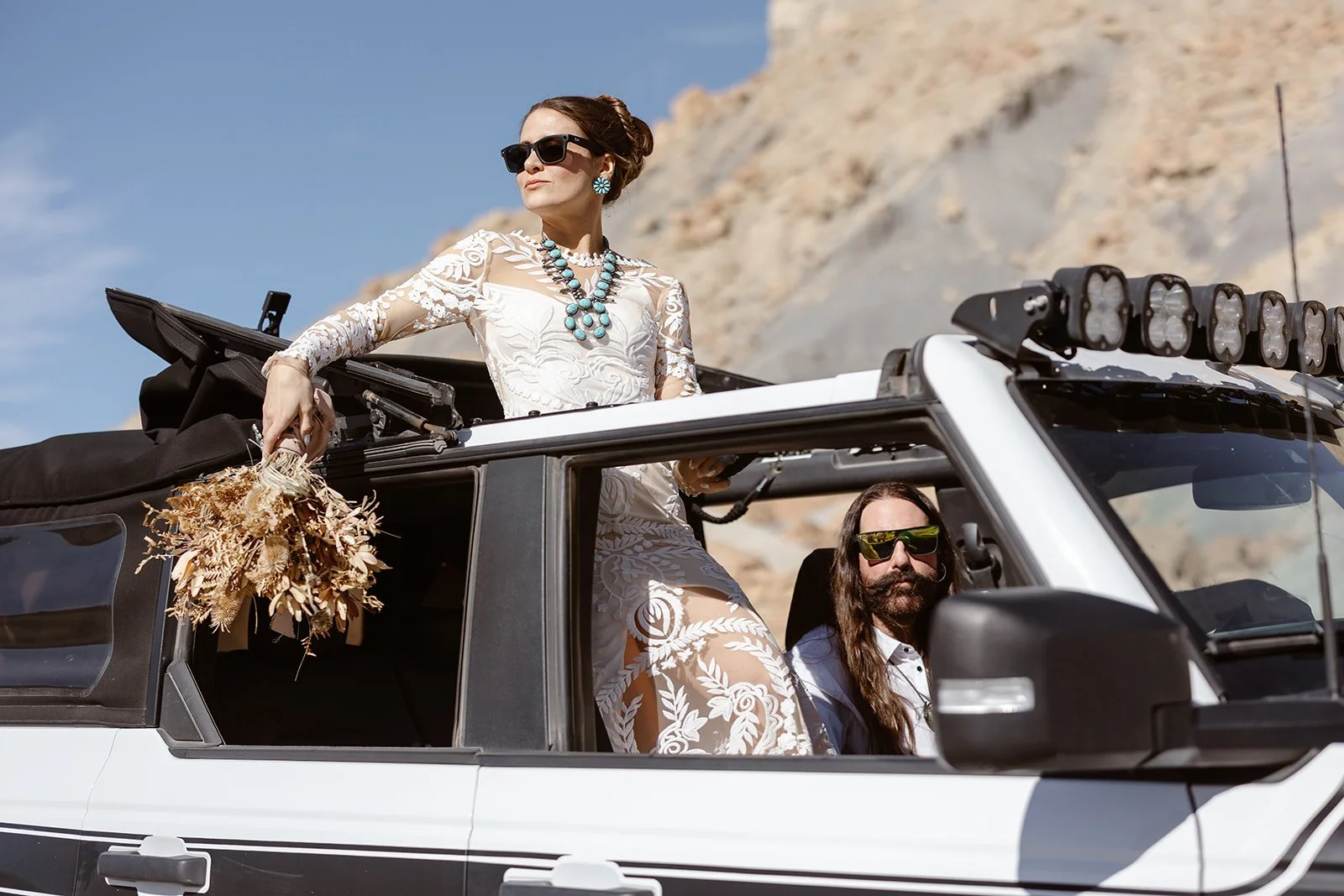 elopement couple looking ahead in their car at lake powell