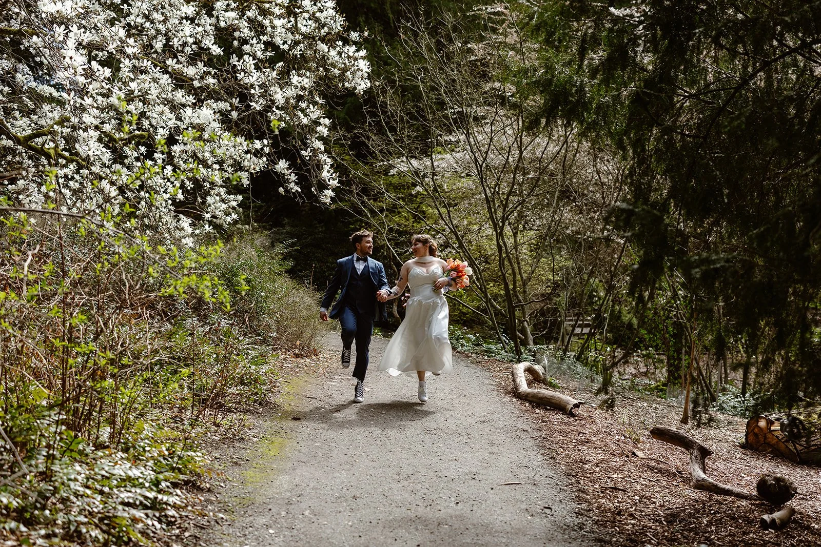 wedding couple skipping at the seattle arboretum for their wedding