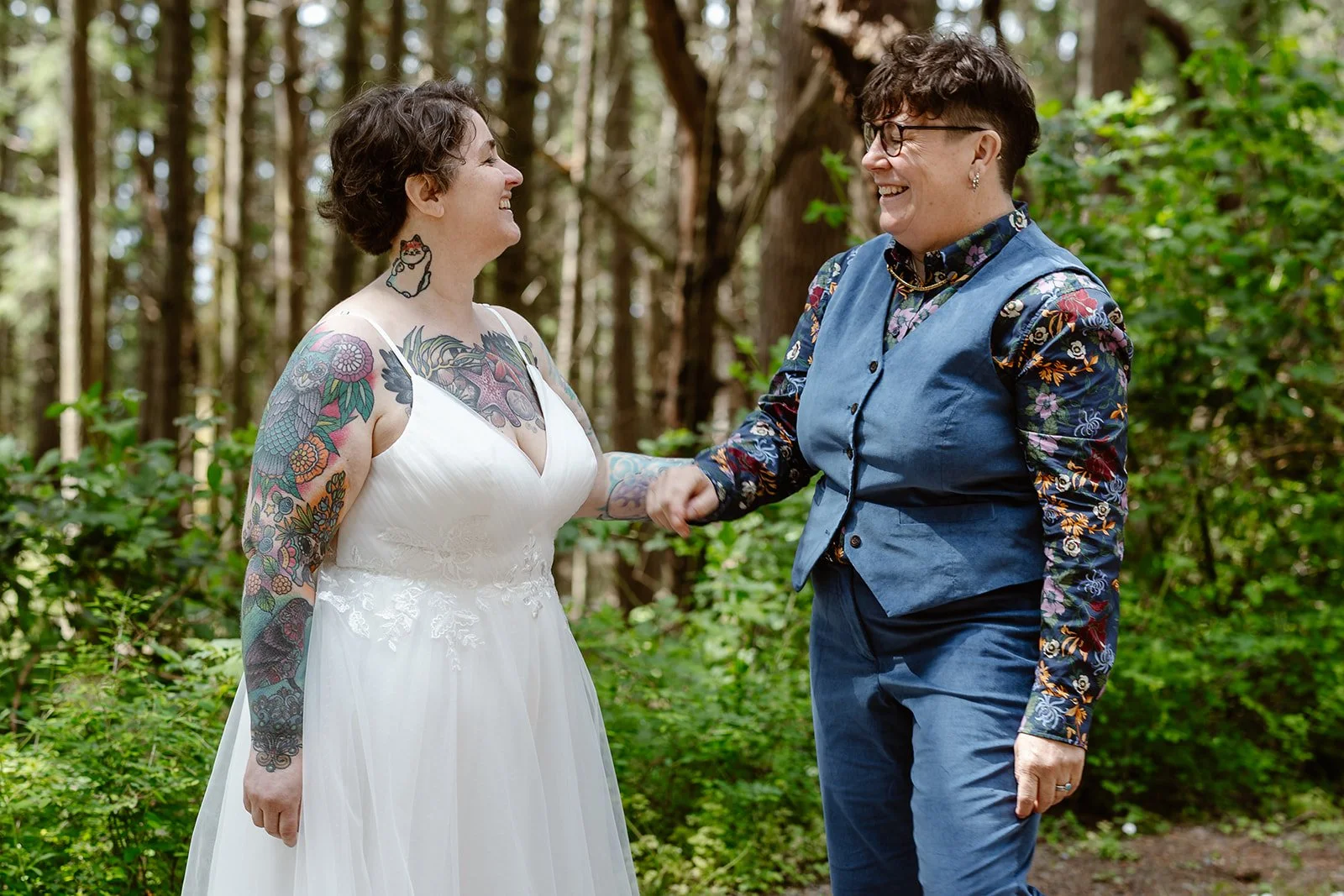 couple smiling at each other for their first look at camano island state park for their wedding