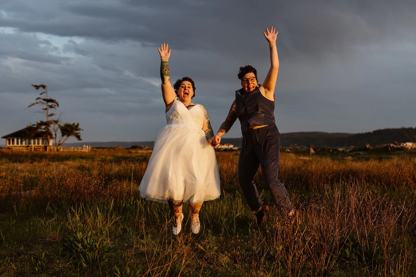 wedding couple jumping in the air for their wedding at camano island state park