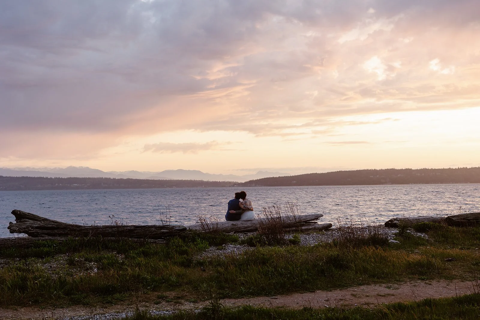 wedding couple looking out at the sunset for their camano island state park wedding