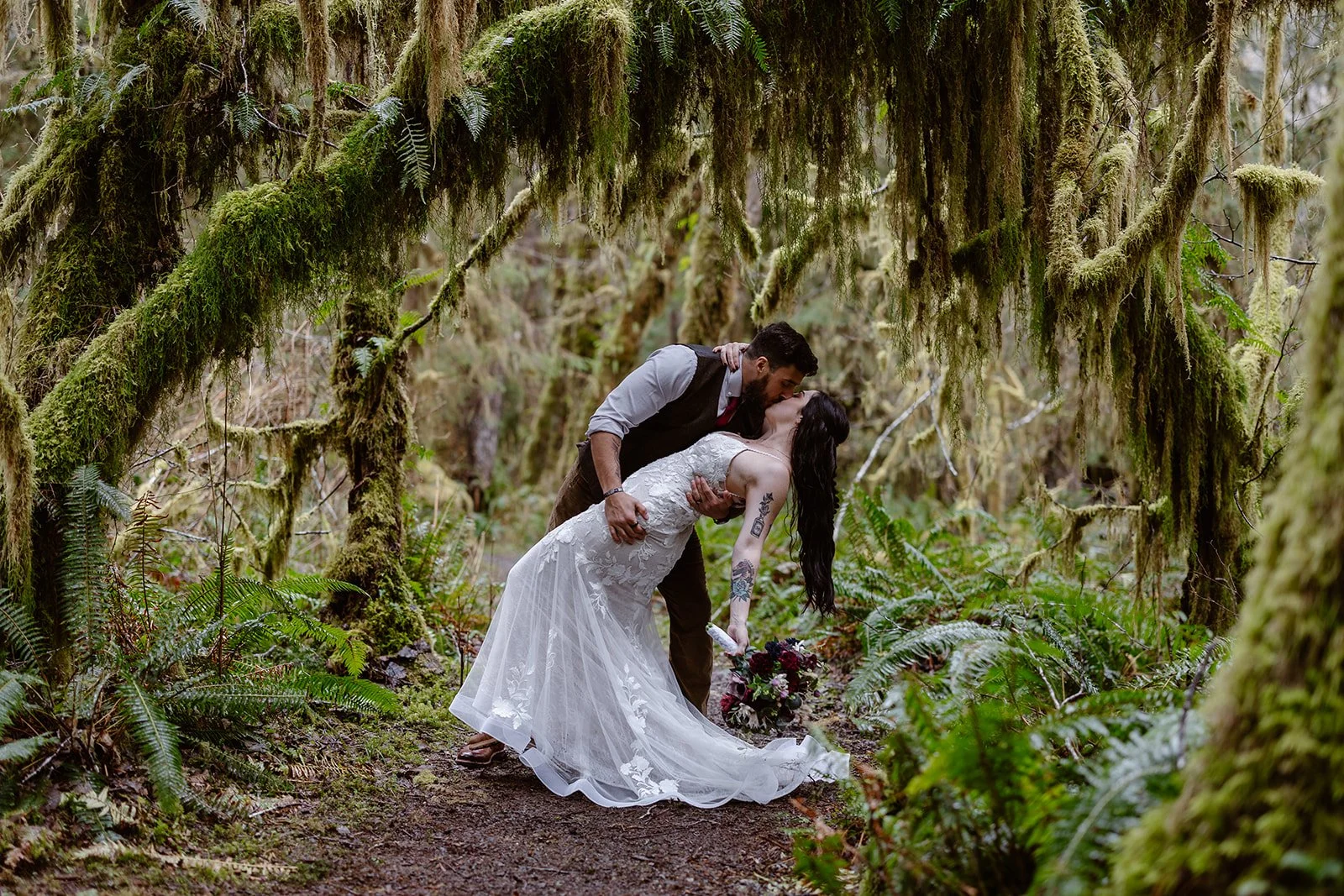 wedding couple kissing in the forest for their micro wedding in washington