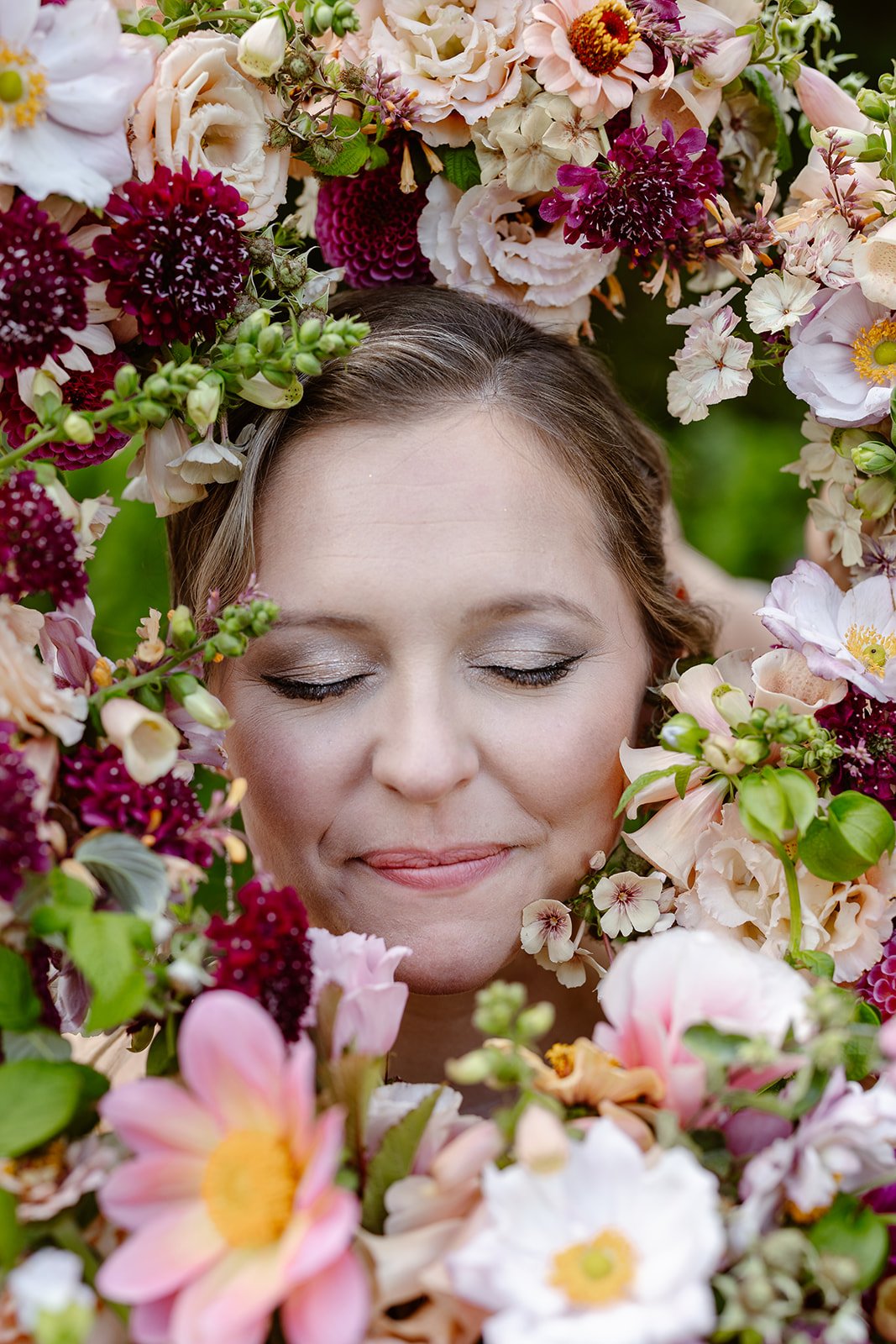 bride smiling with flowers around her for her wedding in washington