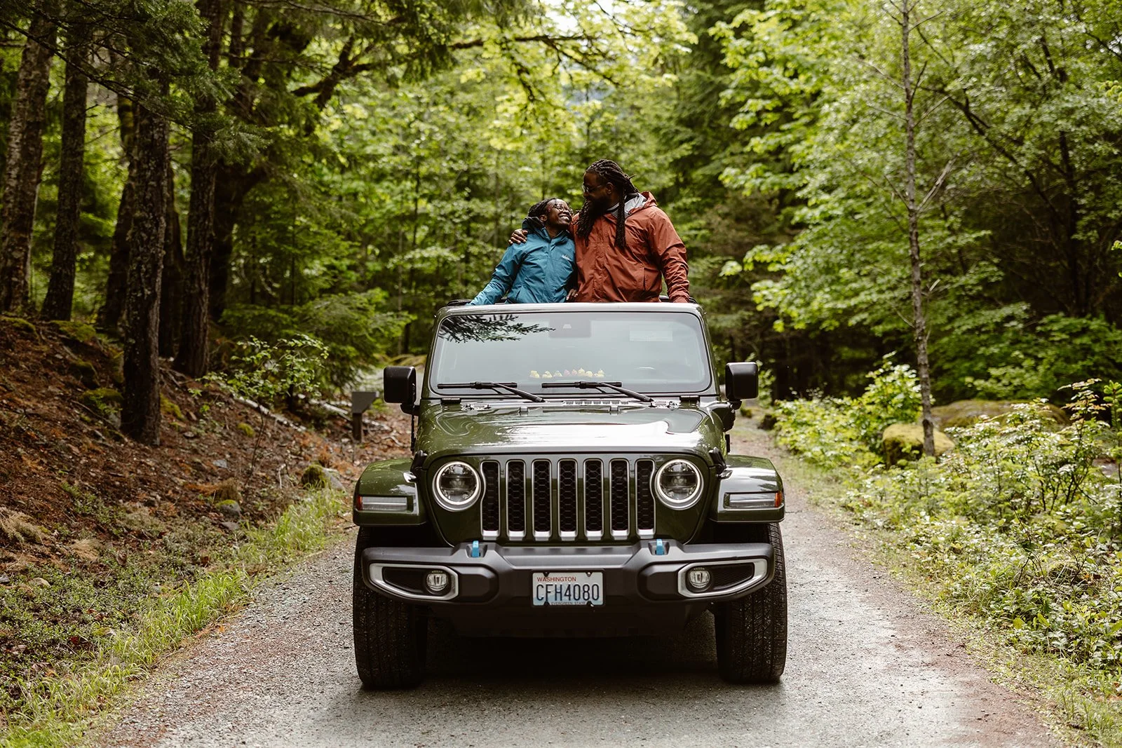 engaged couple standing on their jeep after their engagement session
