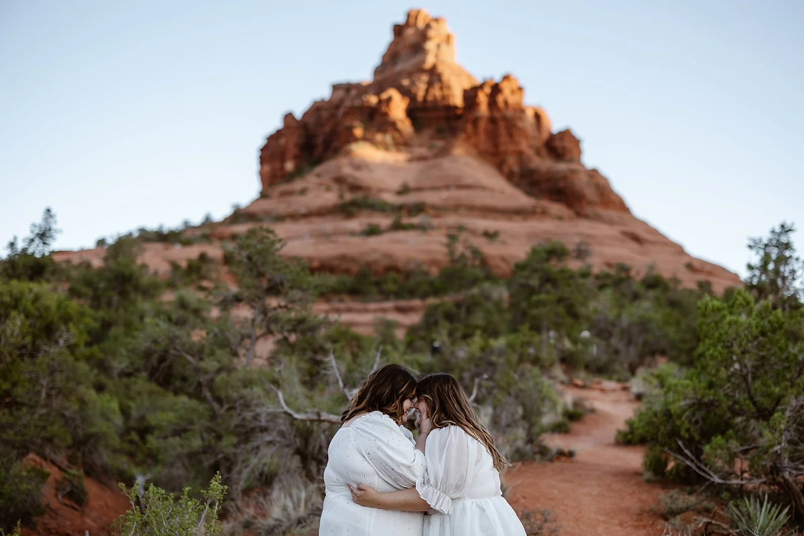 Wedding couple posing underneath Courthouse Butte for their Arizona elopement