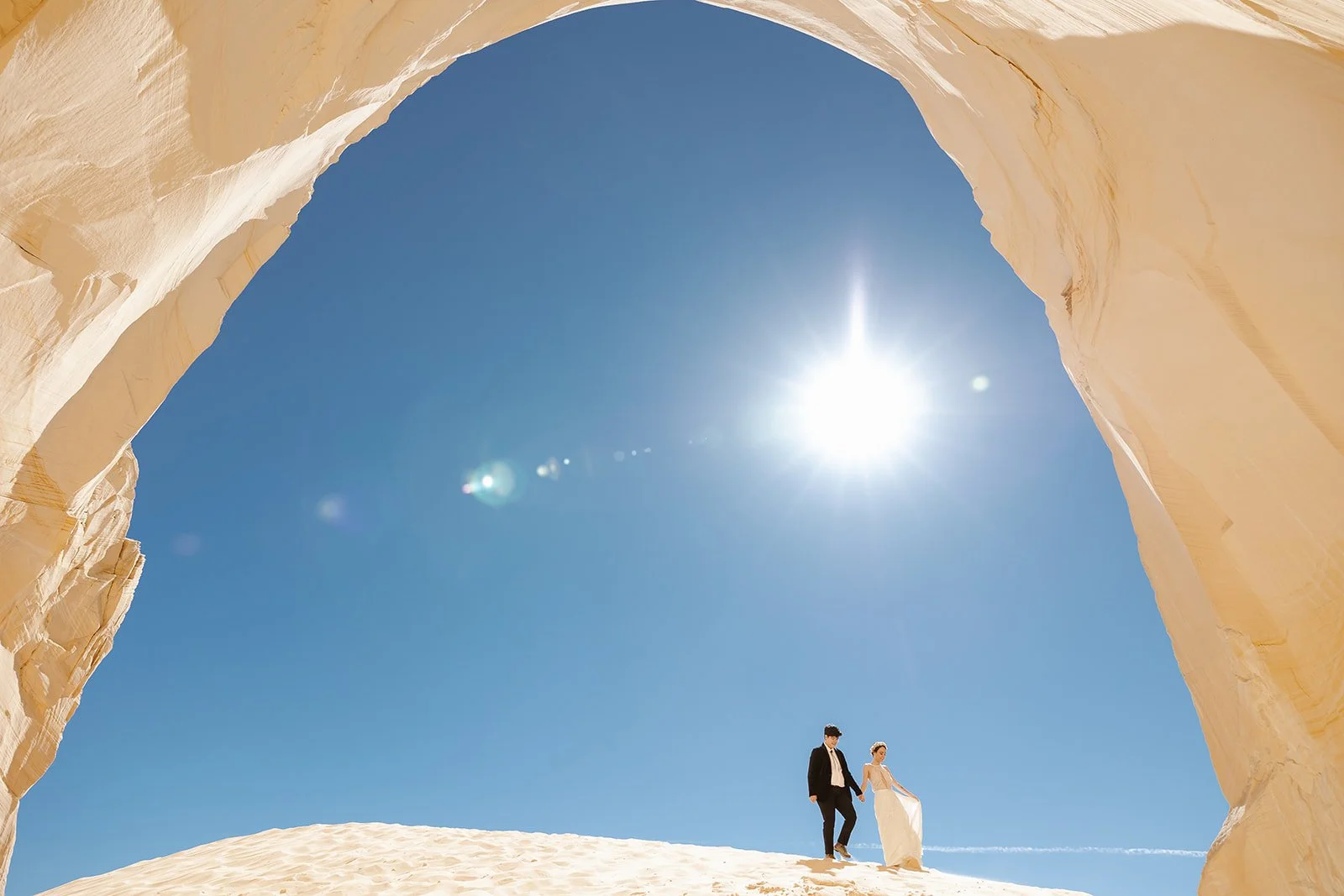 Elopement couple standing under an arch for their page arizona elopement