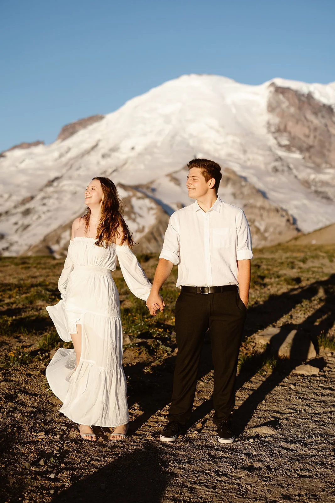couple having changed at their destination for their engagement photos into summer clothes